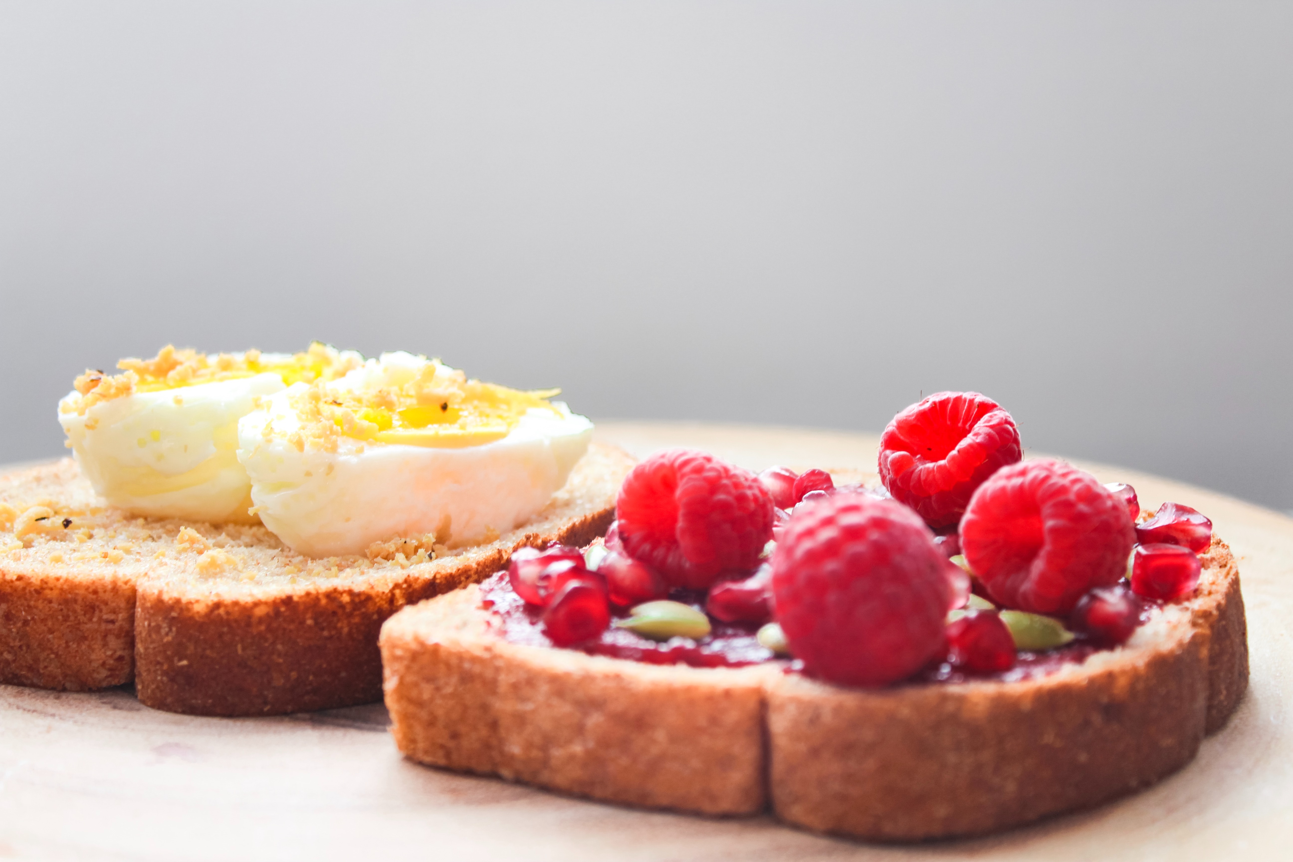 Two boiled egg and raspberries on loaf bread photo