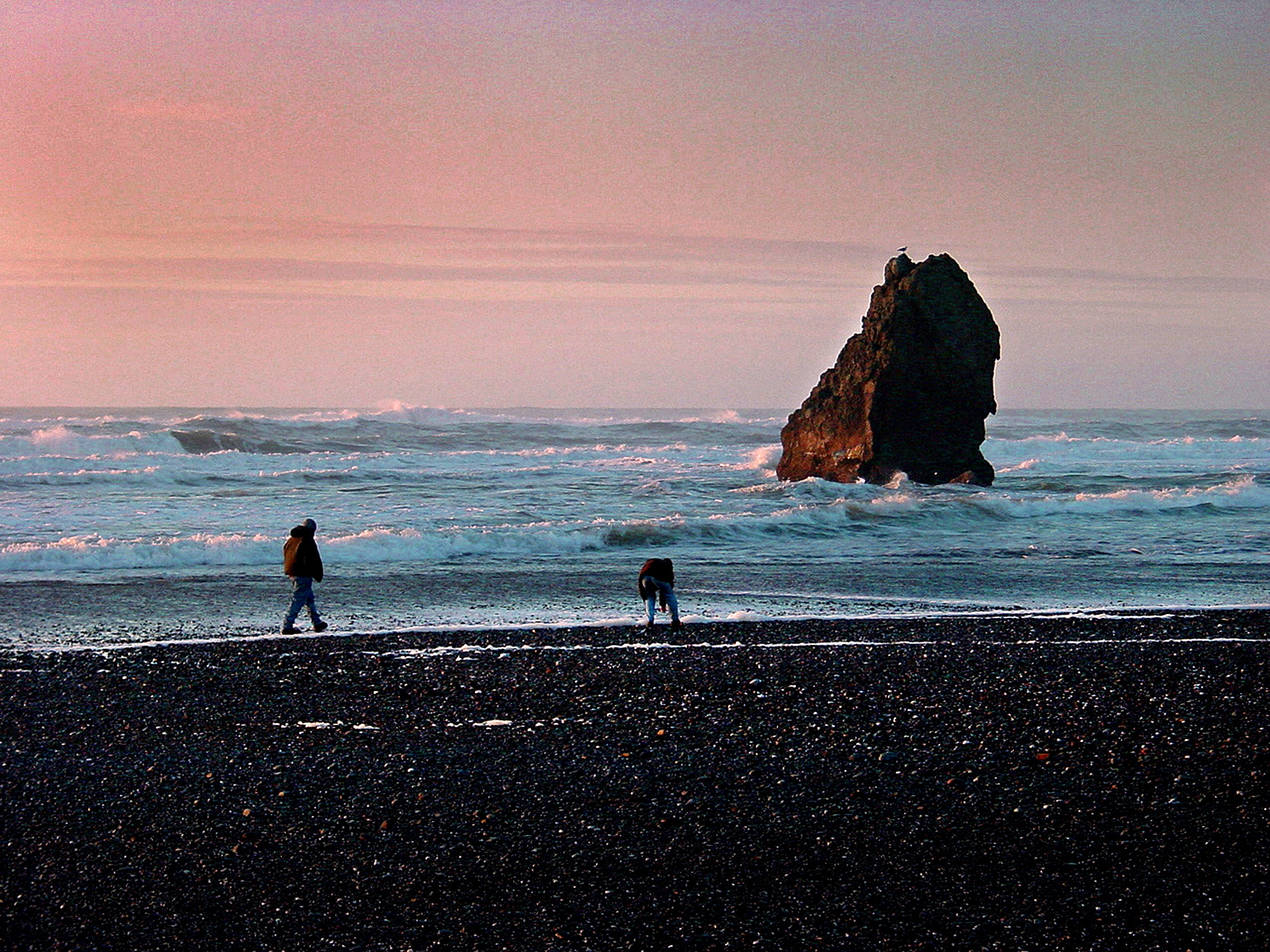 Two people at the seashore during dawn photo