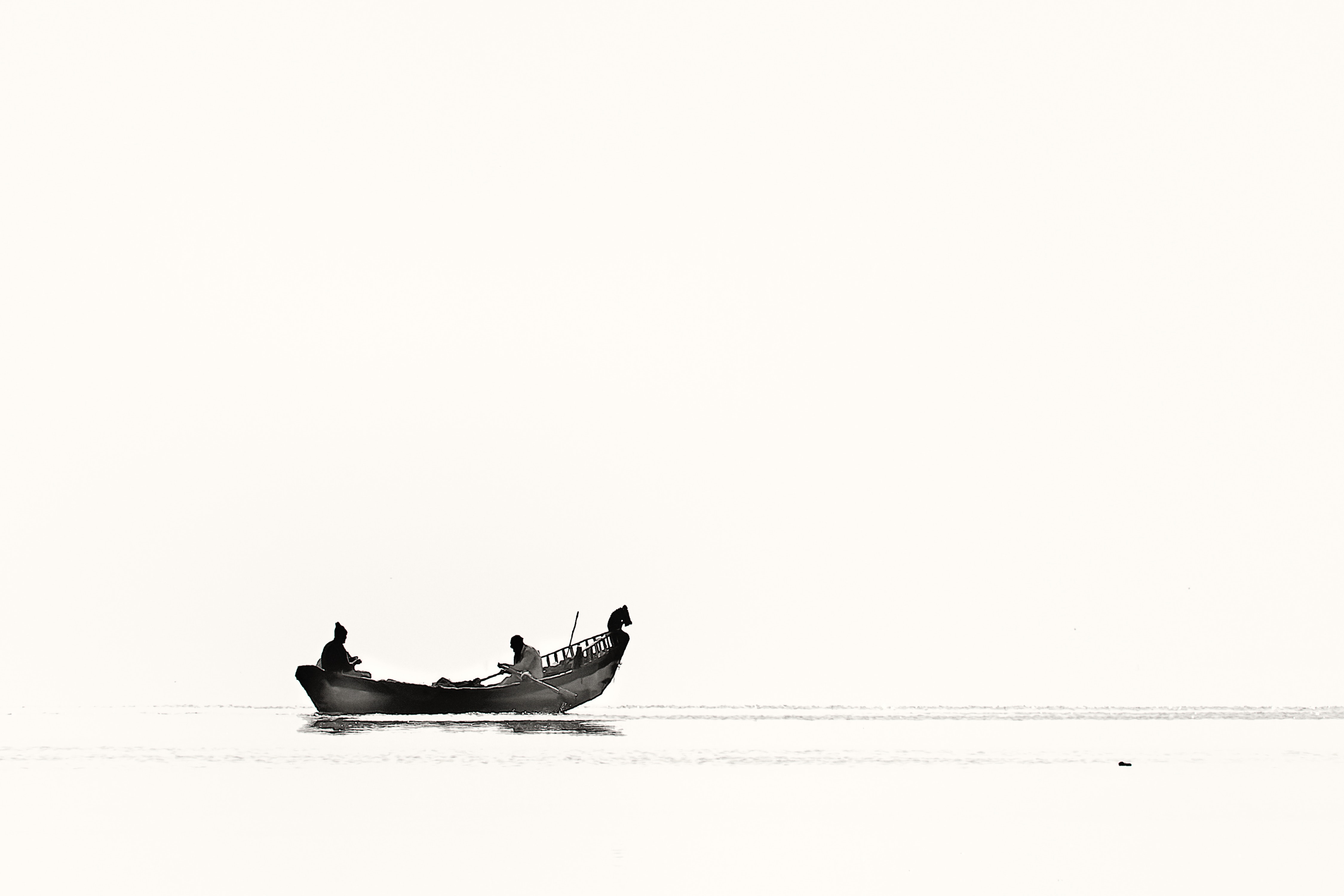 Two person riding boat on body of water photo