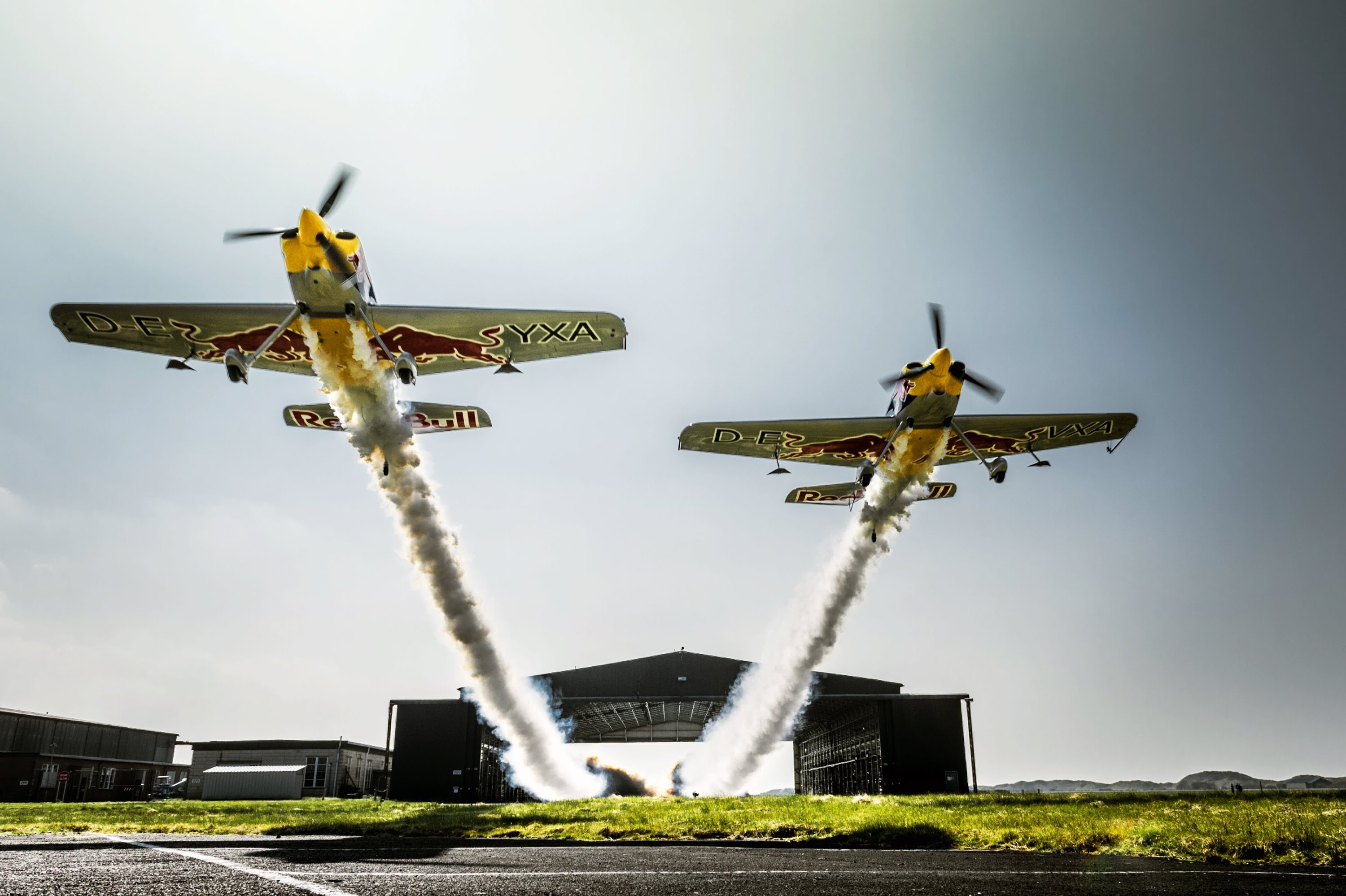 Death-defying Stunt: Two planes fly side-by-side through hangar in ...