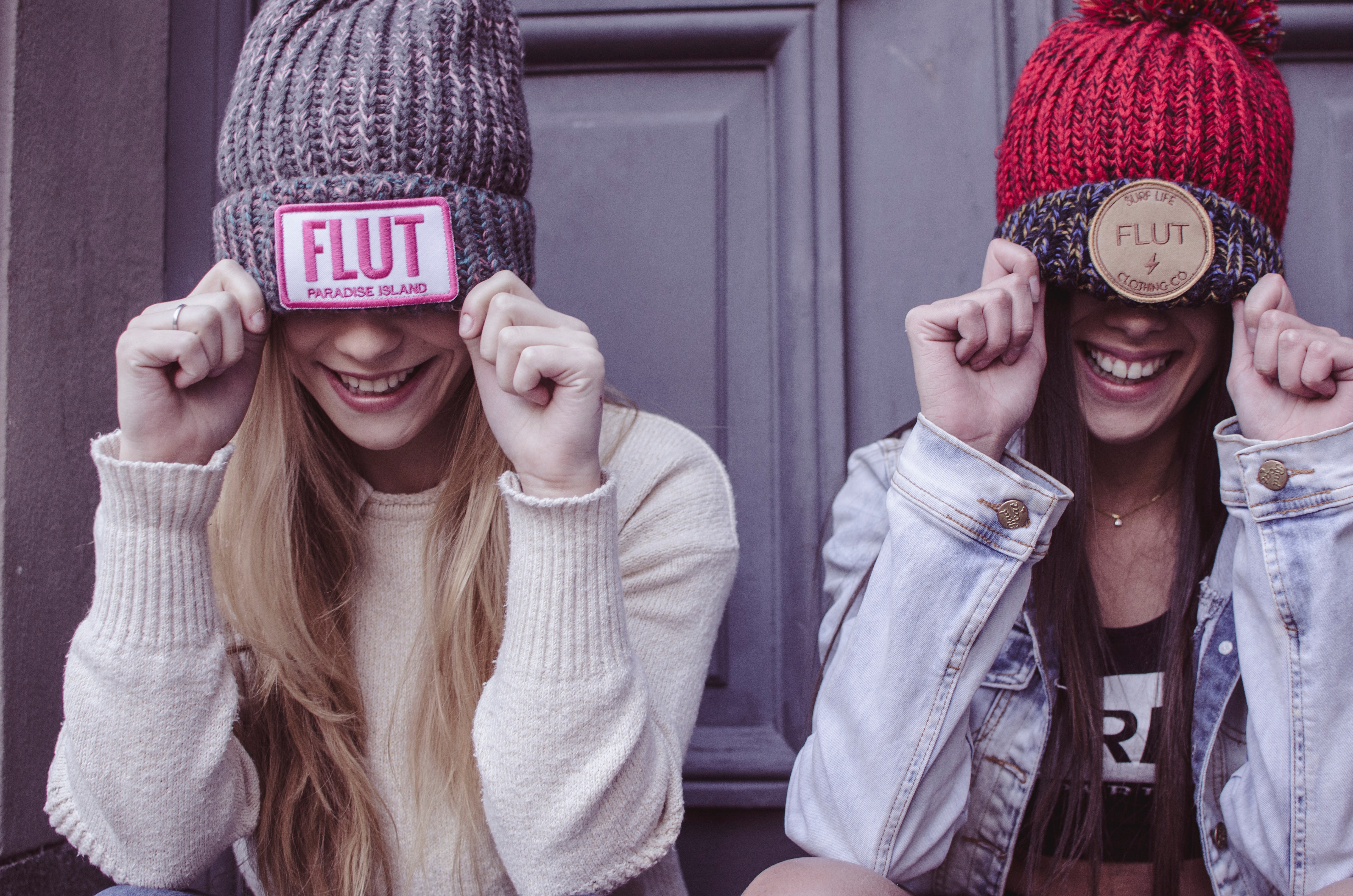Two women's gray and red flut knit caps photo