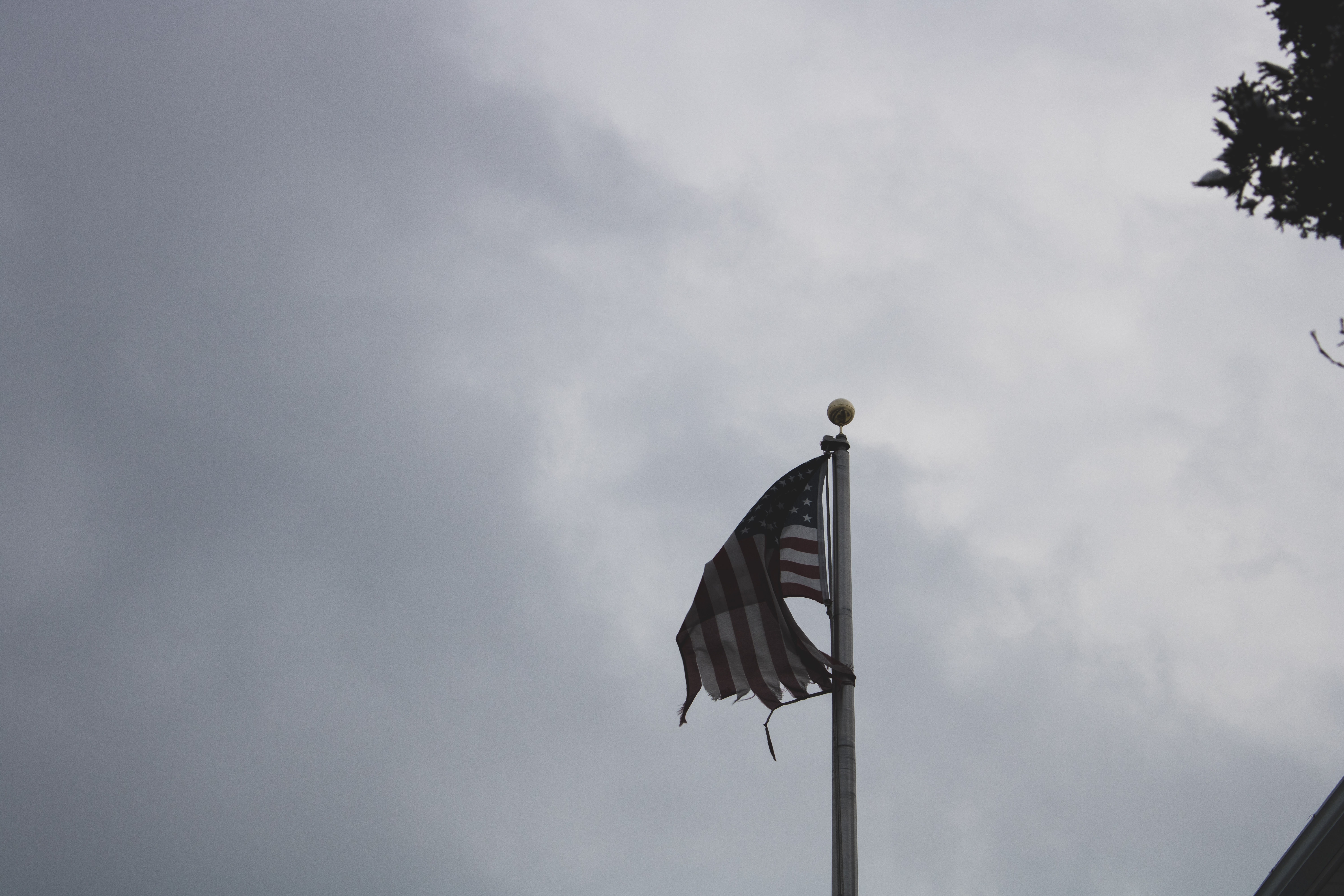U.s.a. flag under gray and white sky photo