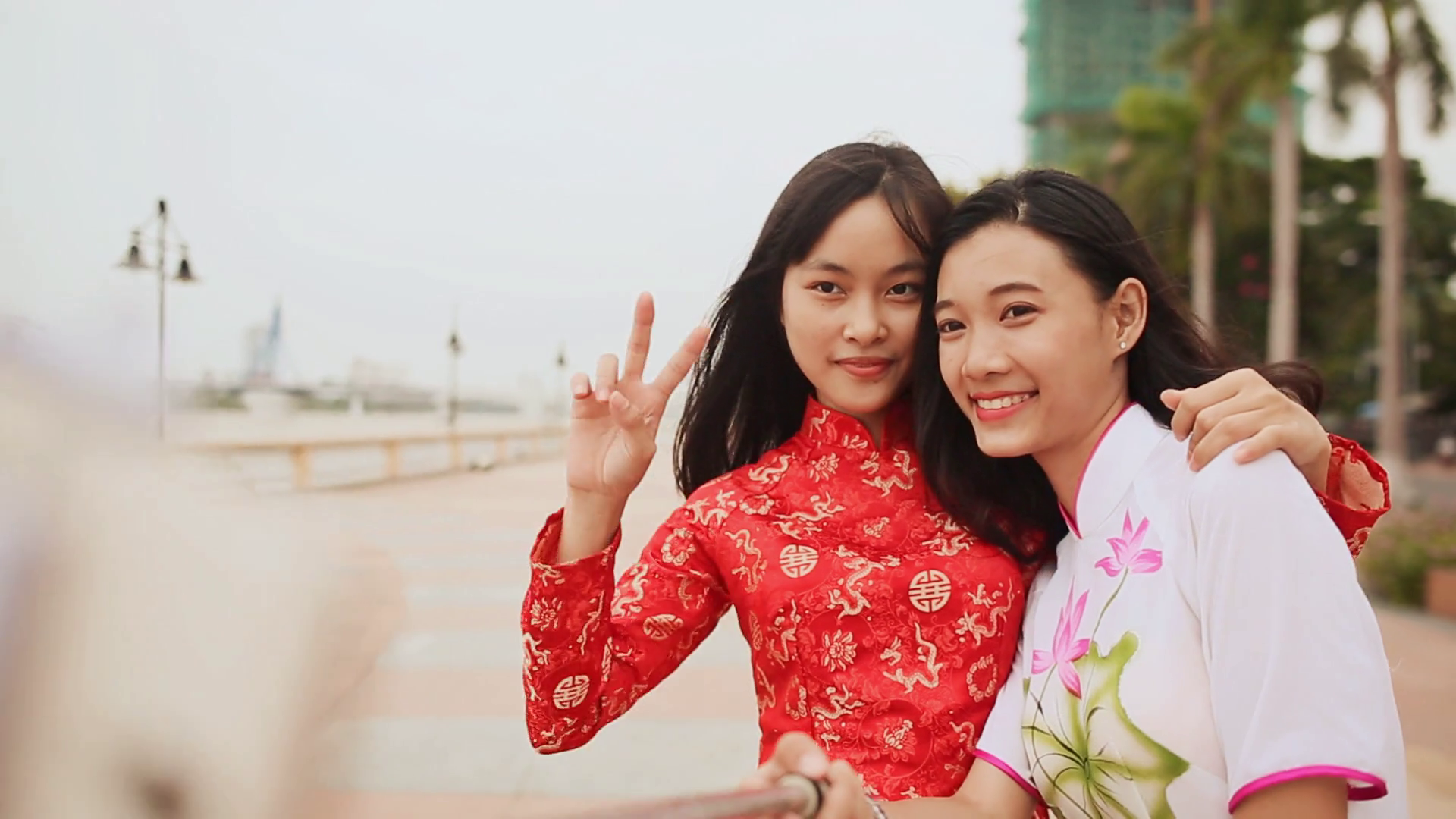 Two beautiful Vietnamese girl doing selfie with phone in national ...