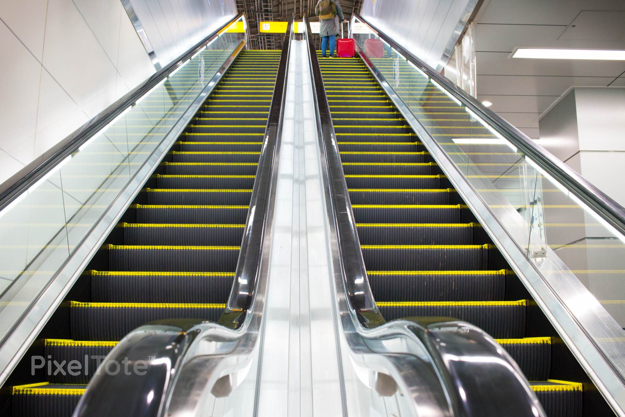 Low Angle View of a Moving Escalators Stock Photo — PixelTote