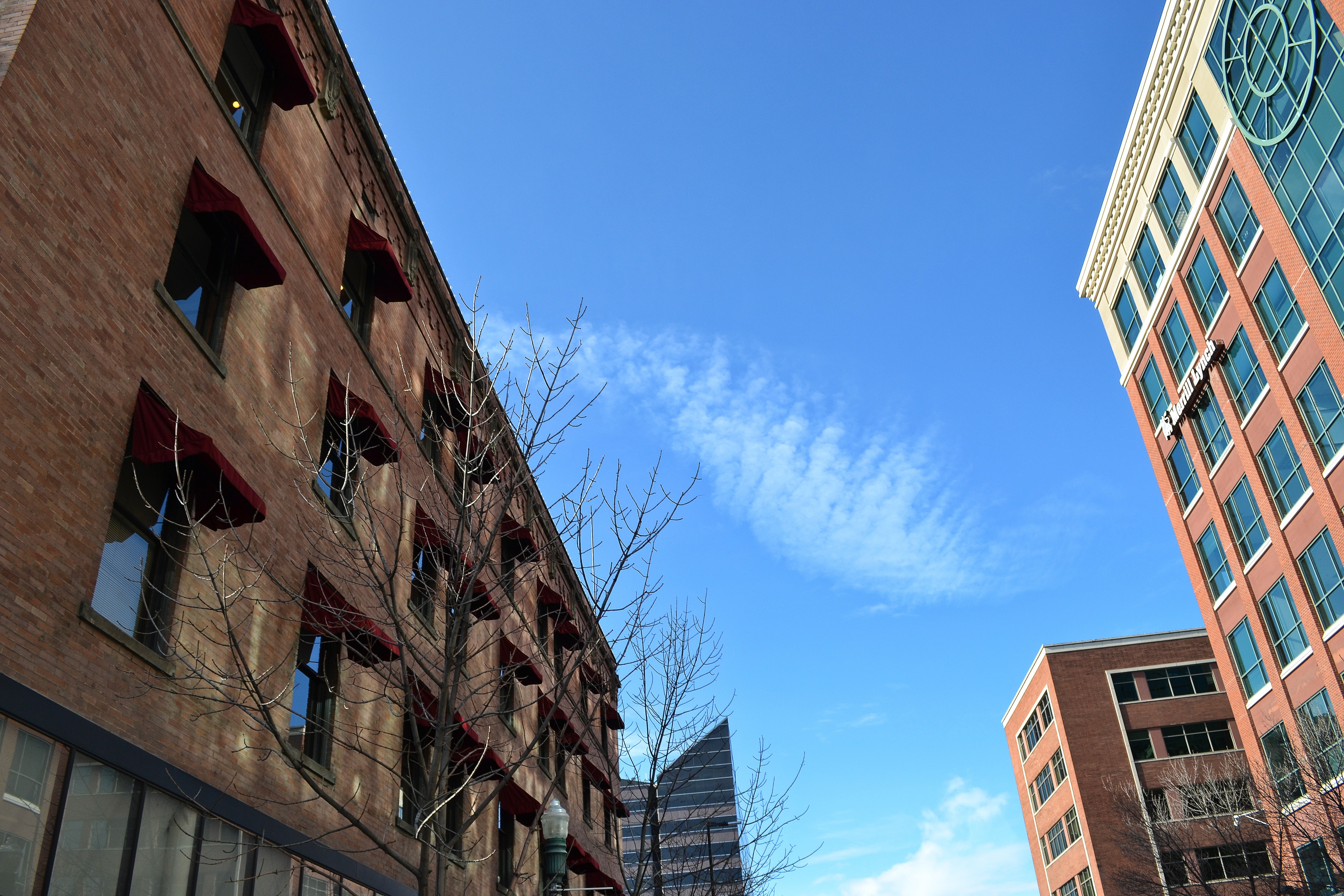 View of the blue sky from city streets with buildings photo