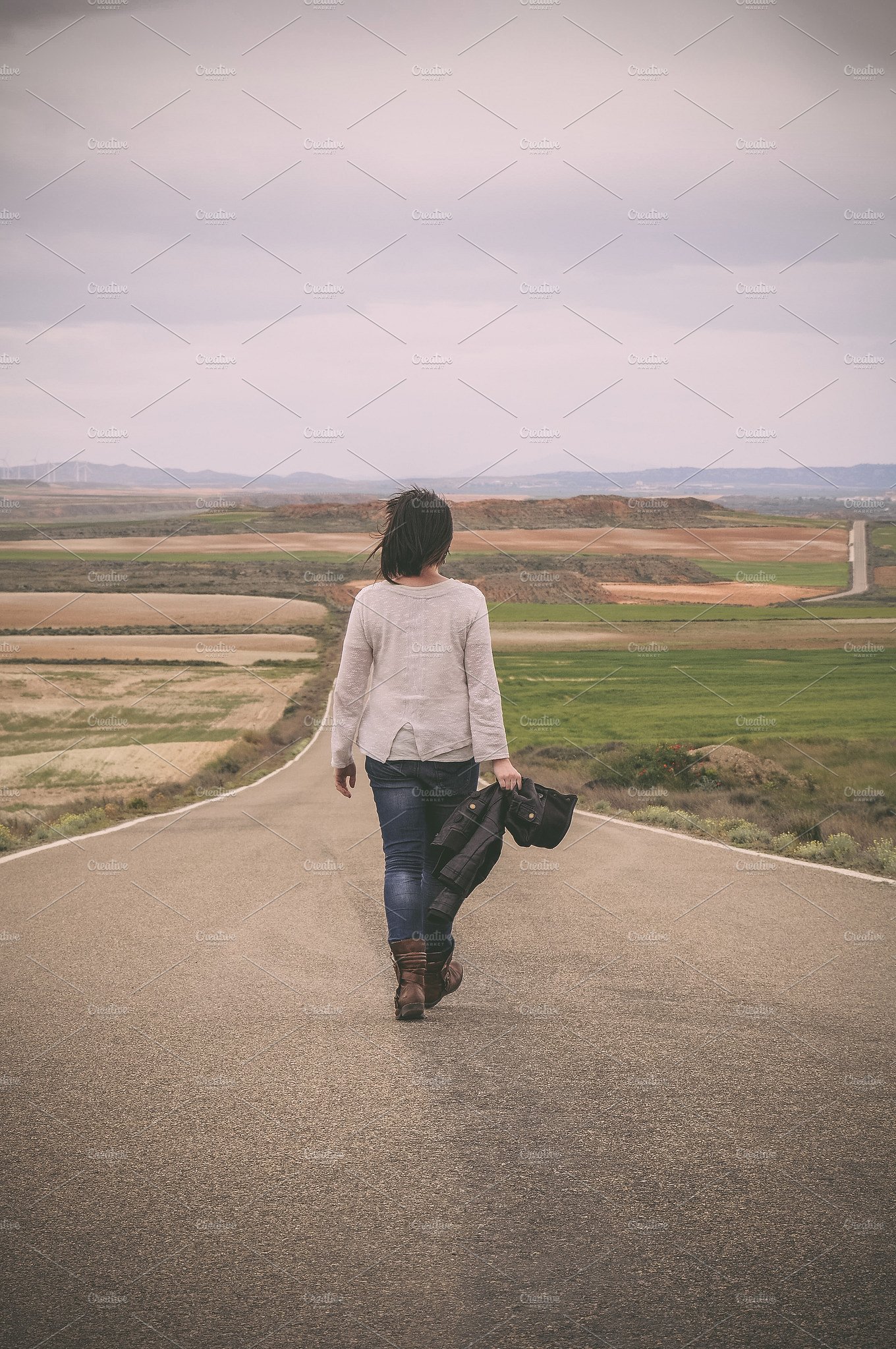 Woman walking alone in a road ~ People Photos ~ Creative Market