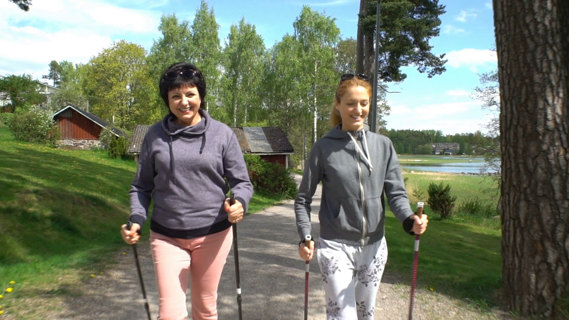 Nordic walking outdoor activity for all ages. Two active women ...