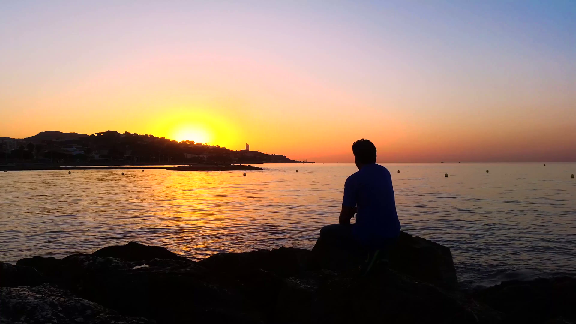 Man sitting among the rocks watching the sunrise Stock Video Footage ...
