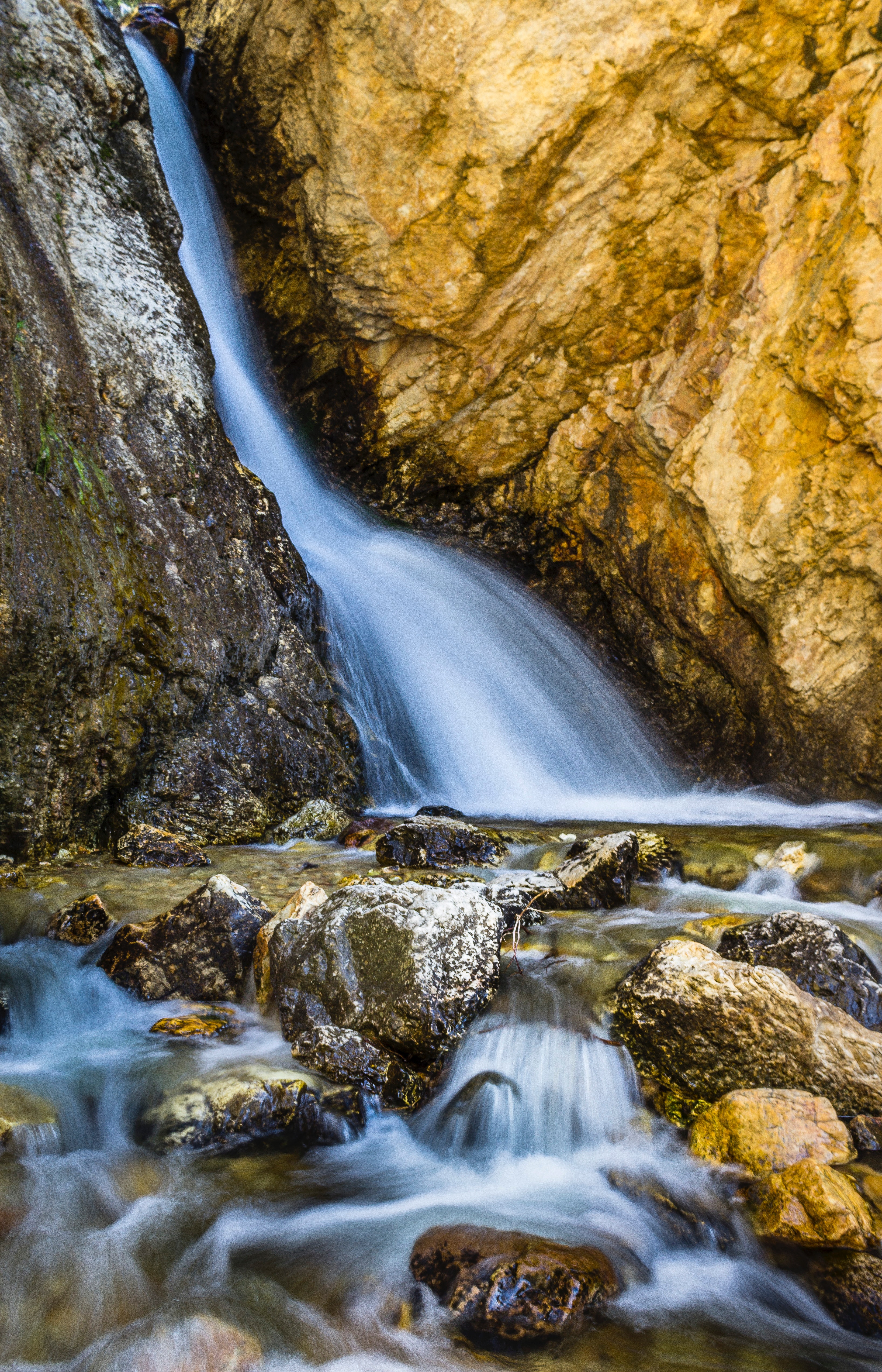 Water stream between brown rocks photo