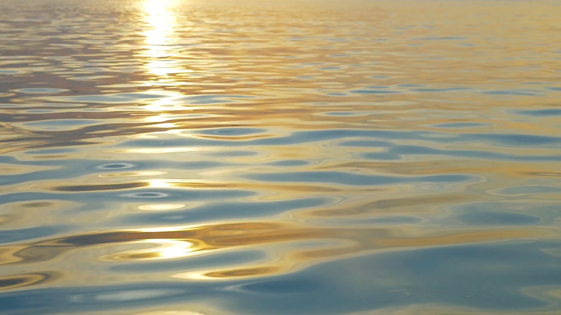Slow motion of sea water with slight ripple sparkling in light of ...