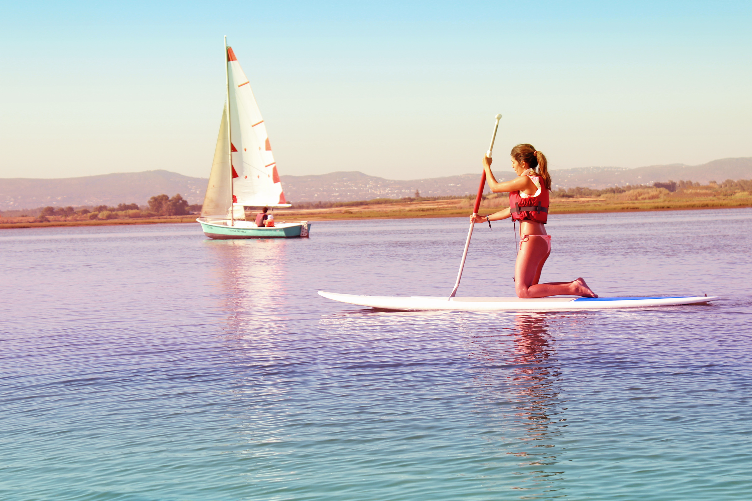 Watersports - girl practicing on paddle board photo