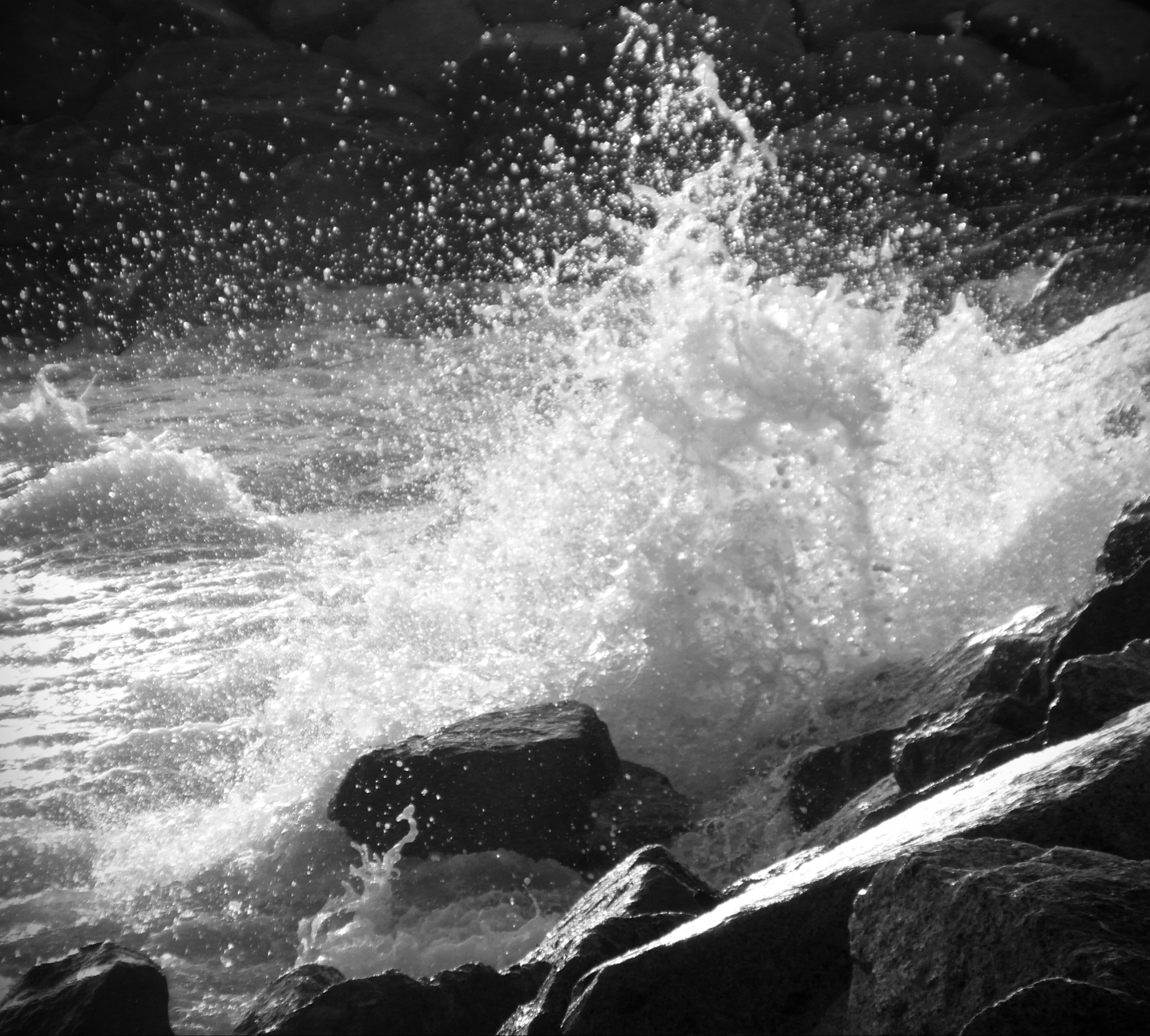 Waves crashing against rocks photo