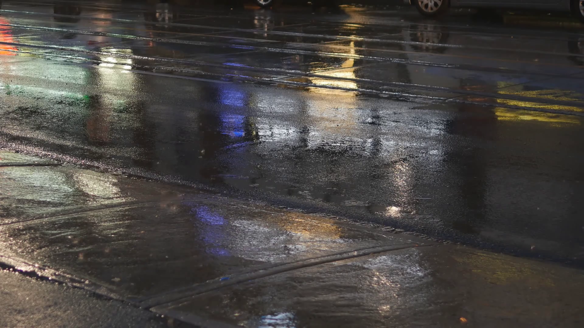 Detail of wet city street on rainy night. Traffic passing by. Good ...