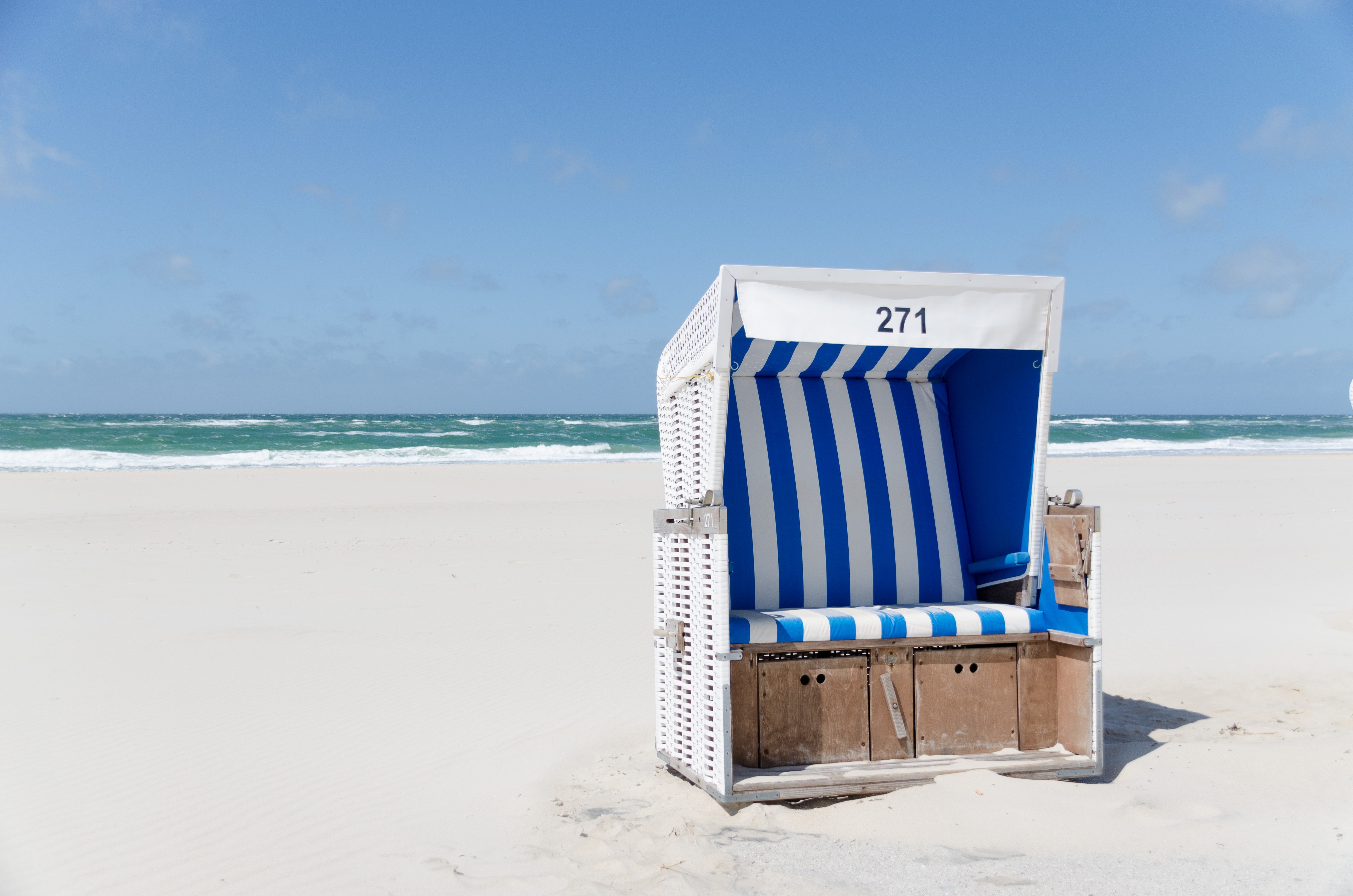 White and blue stripe booth number 271 on seashore during daytime photo