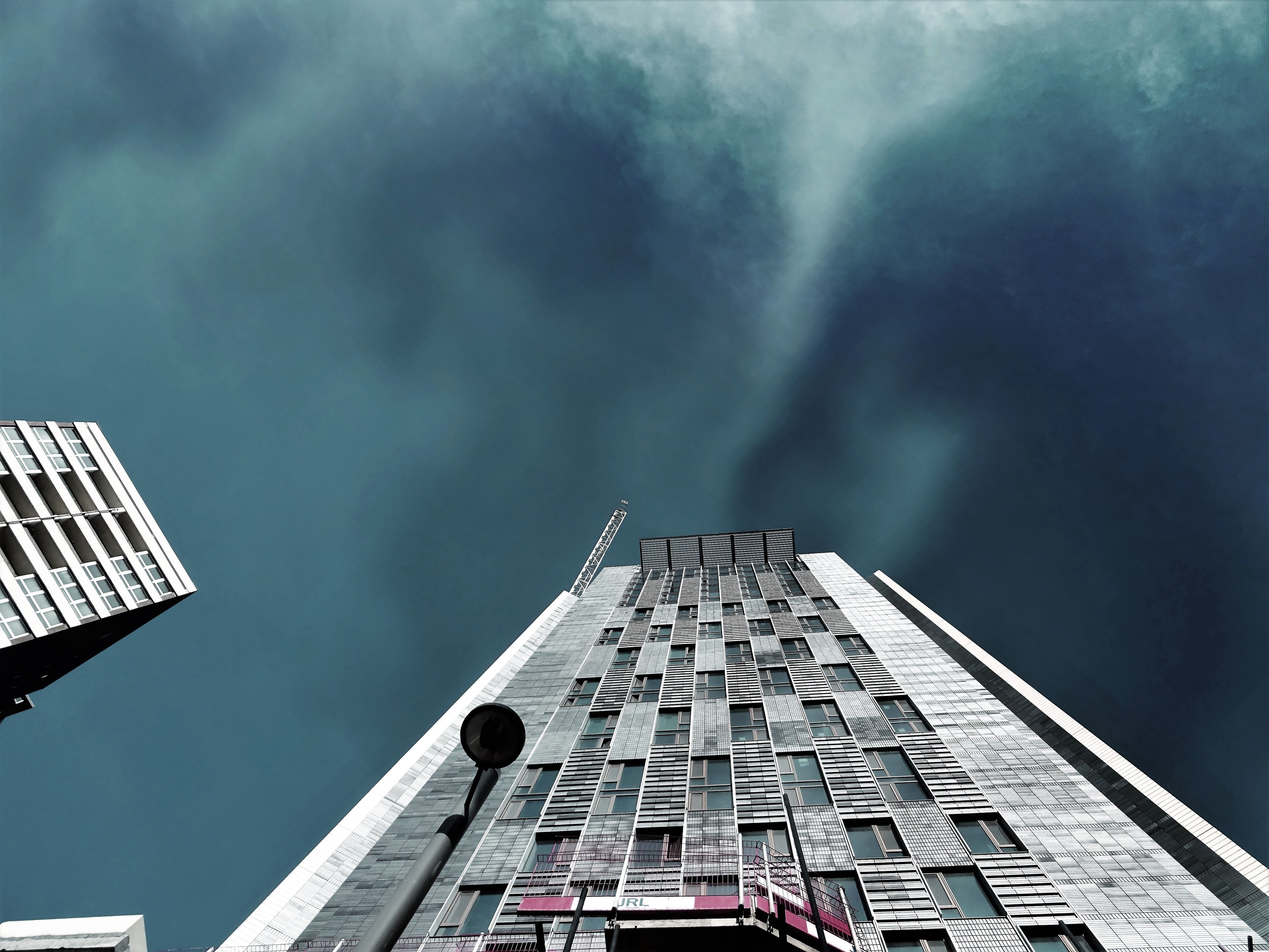 Worms Eye-view Photography of White High-rise Building during Storm ...