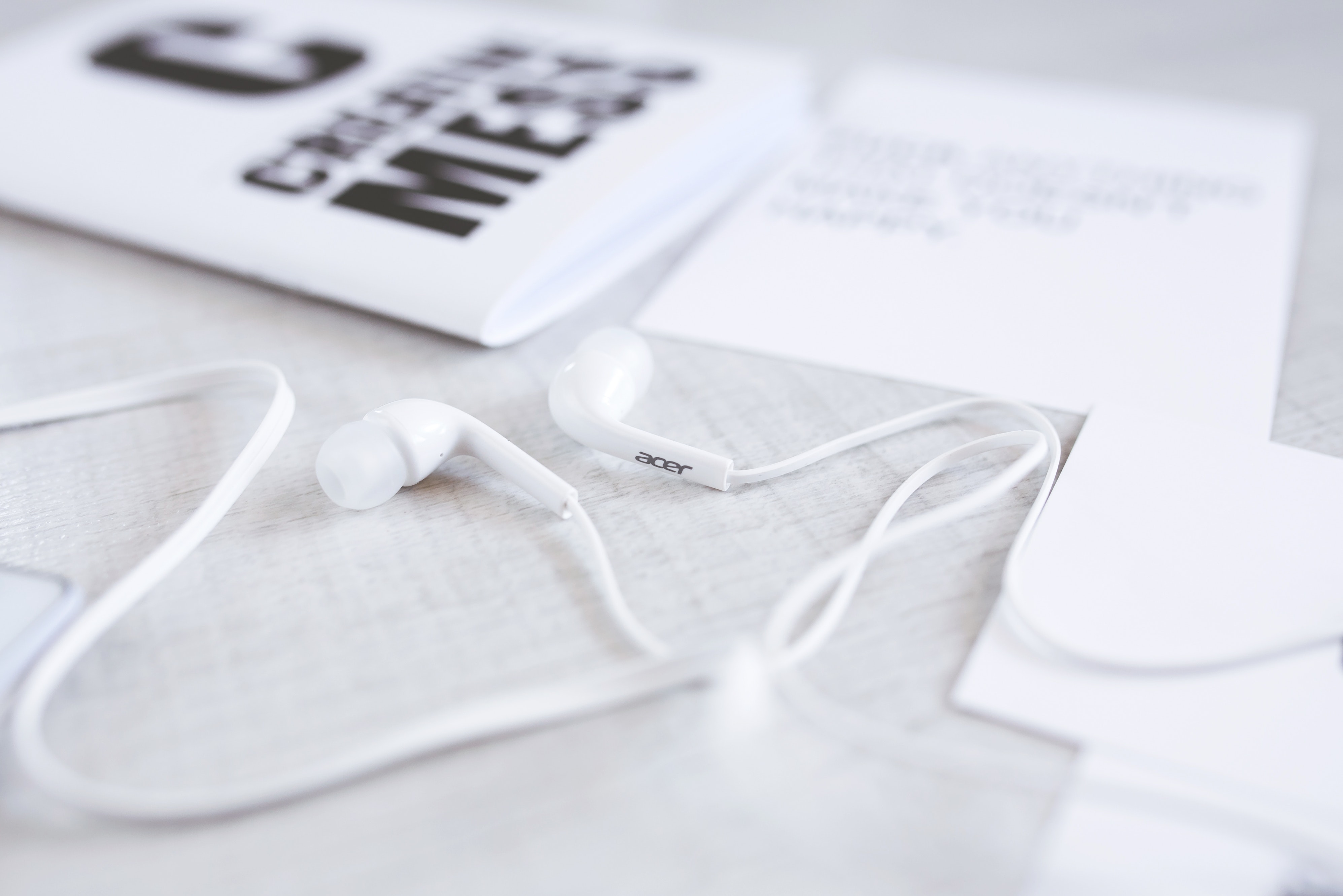 White and modern earphones on a desk photo