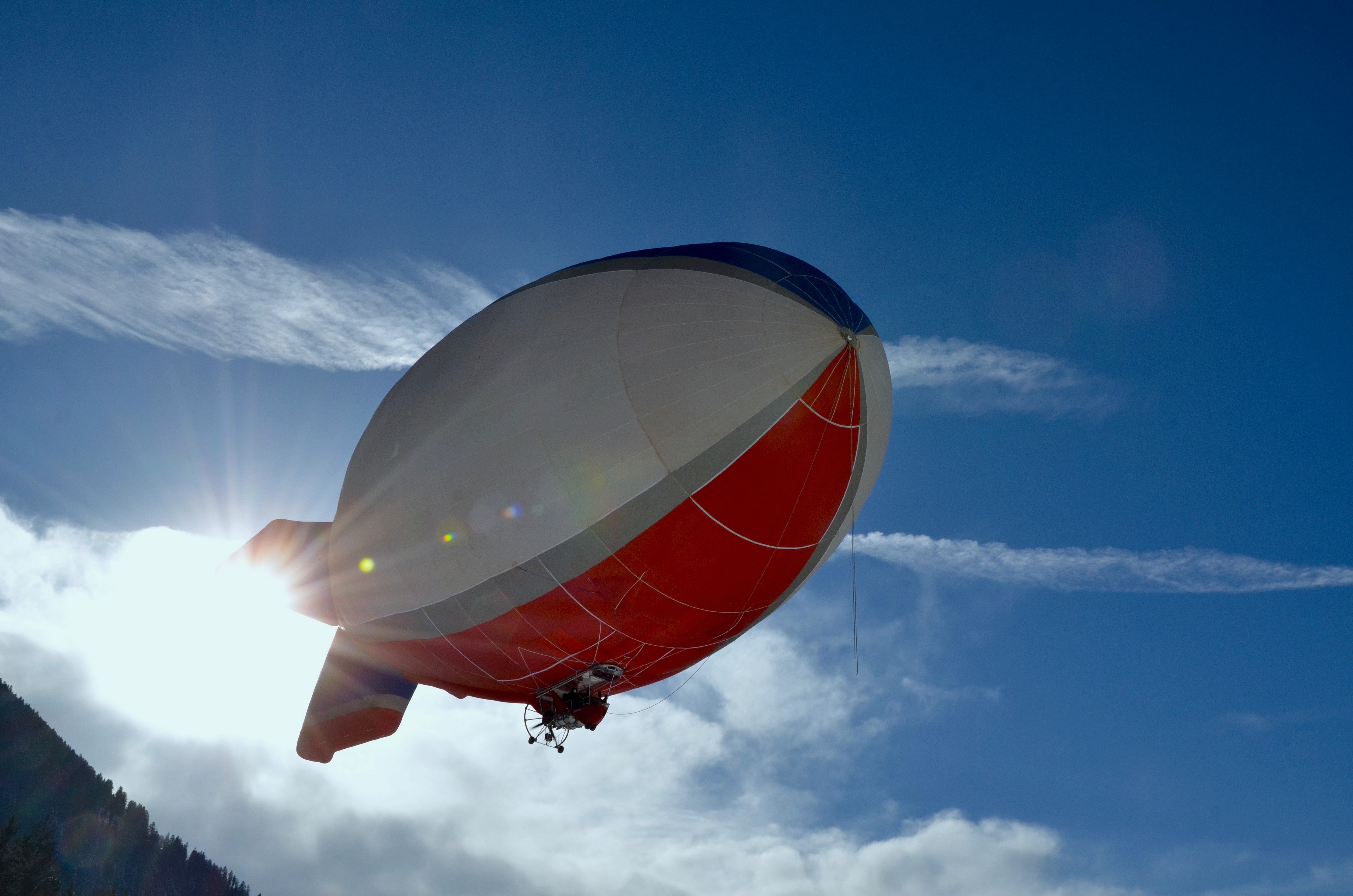 White and red blimp flying photo