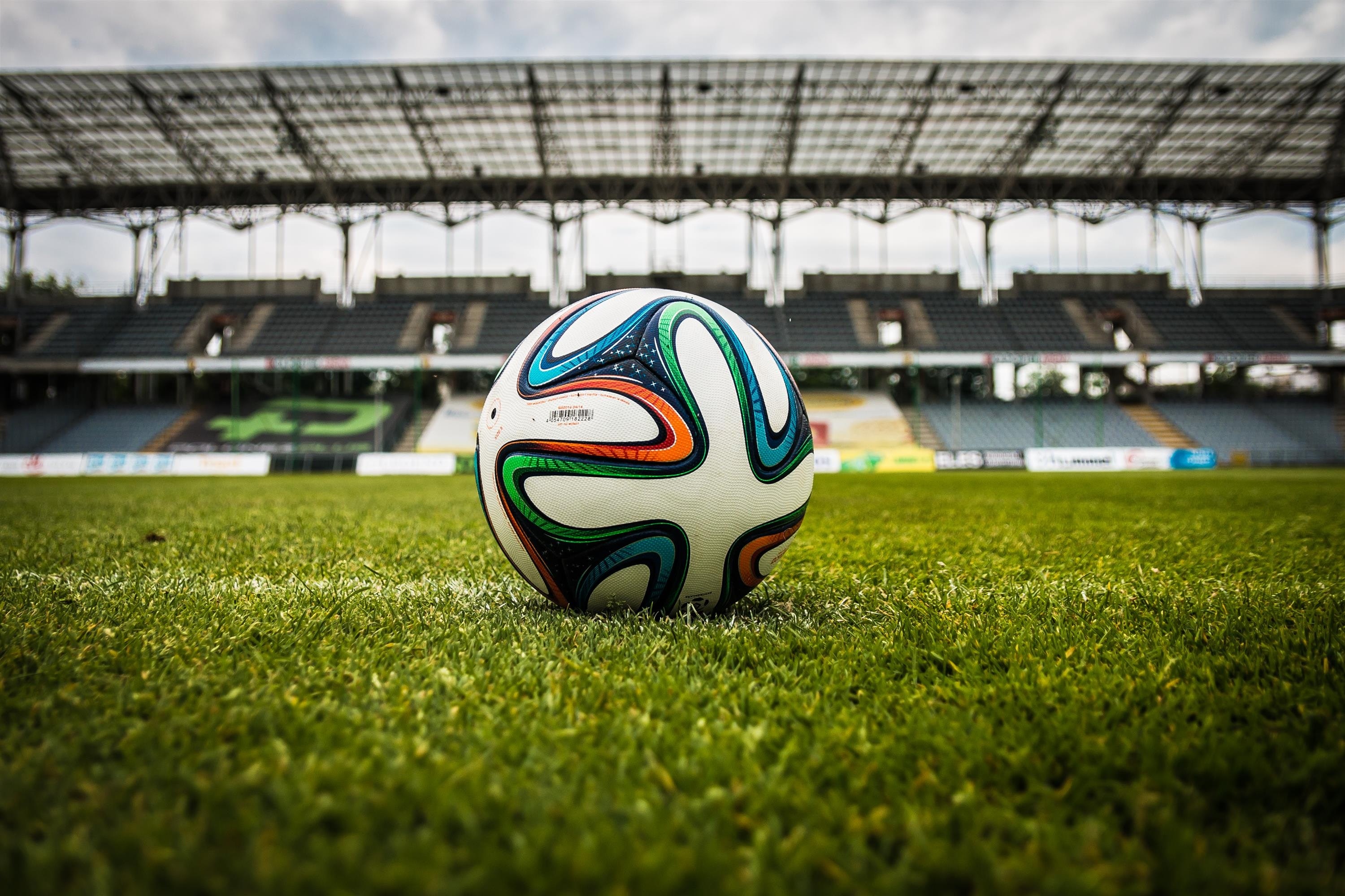 White black and green soccer ball on soccer field photo