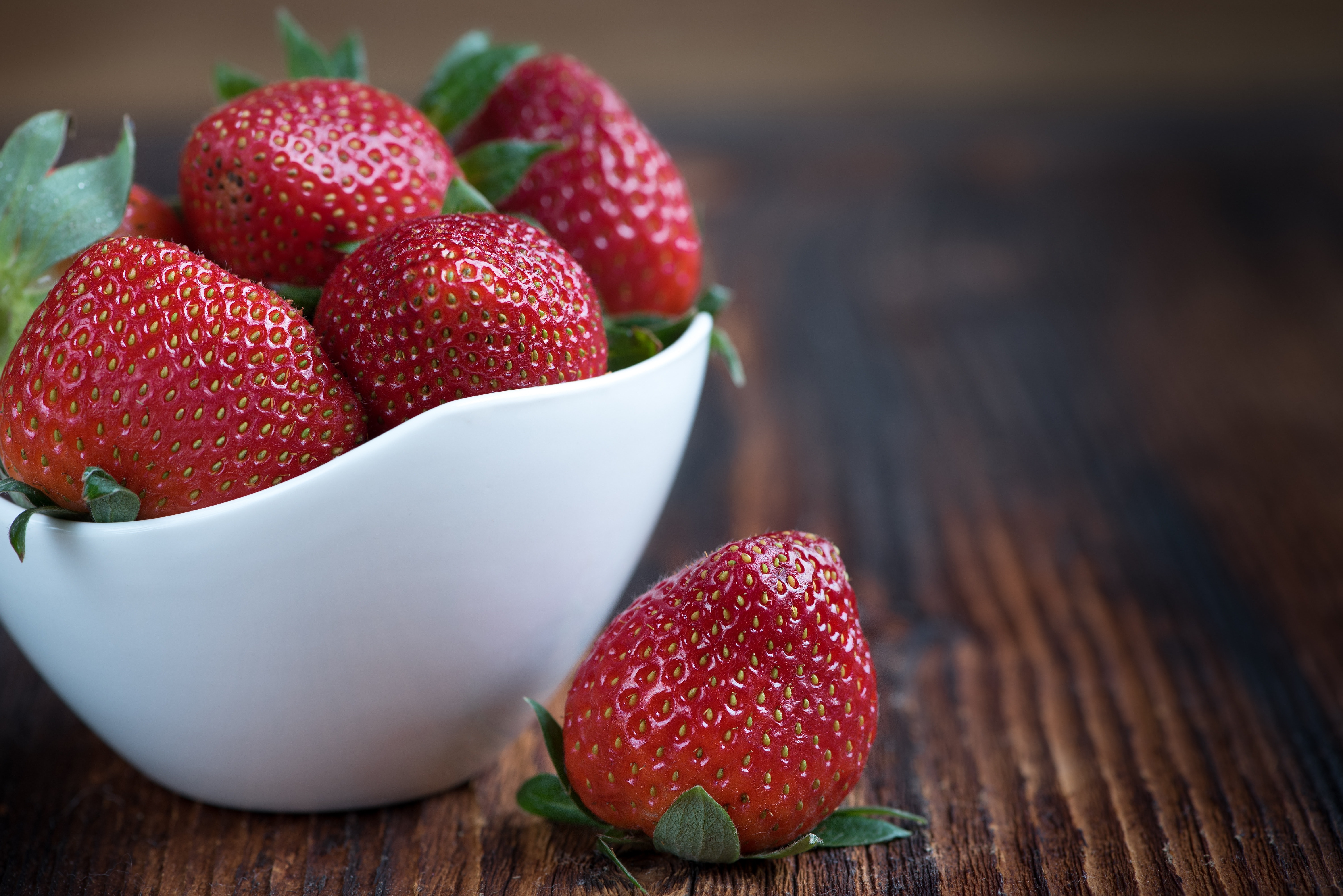 White bowl of whole strawberries photo