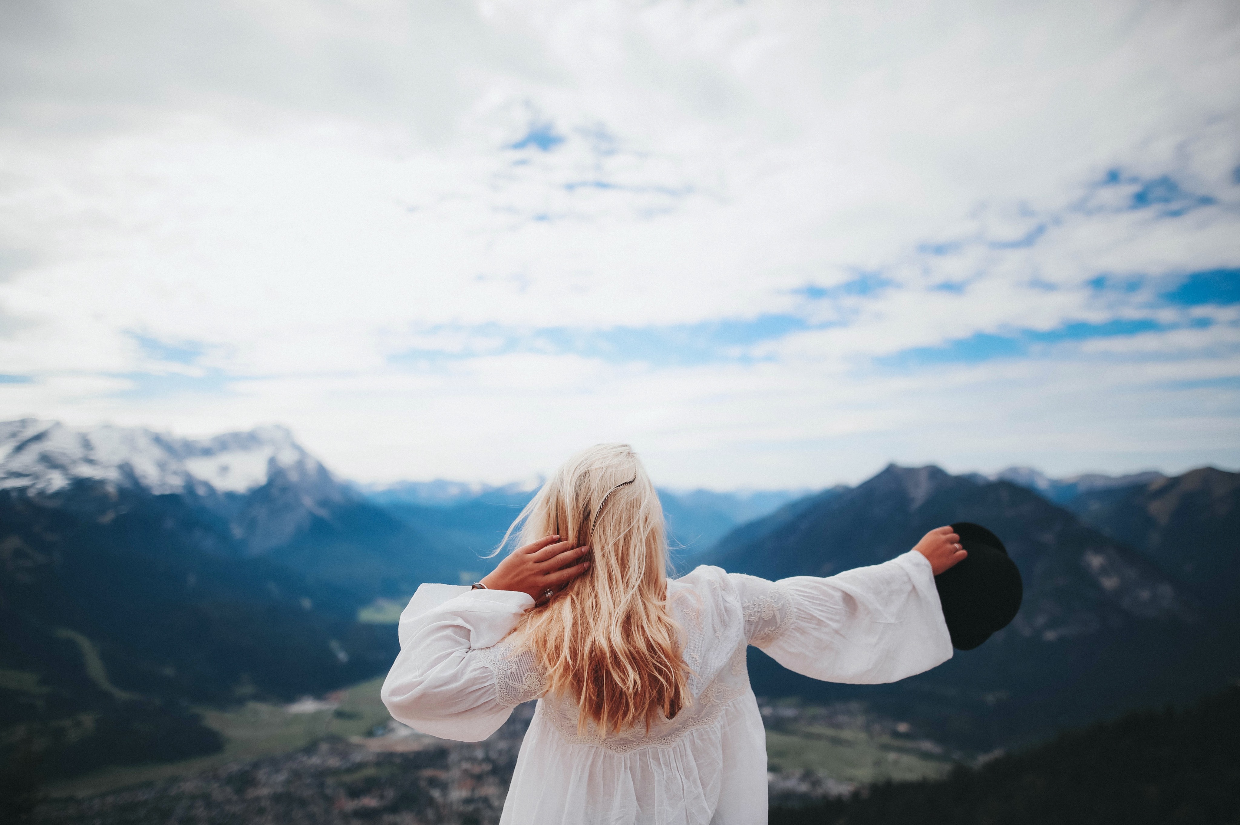 White dressed girl across black mountains photo