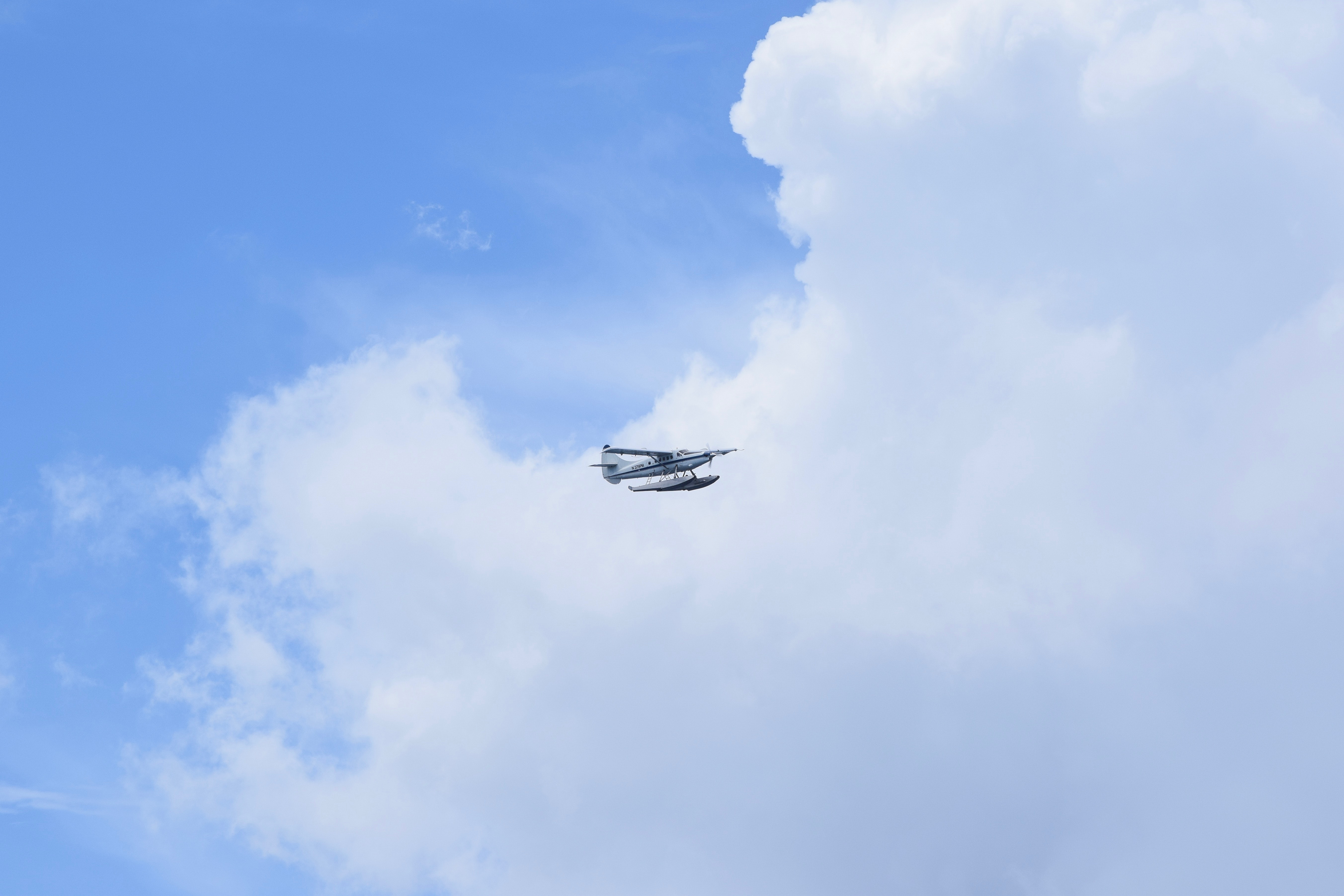 White hydroplane flying on the sky photo