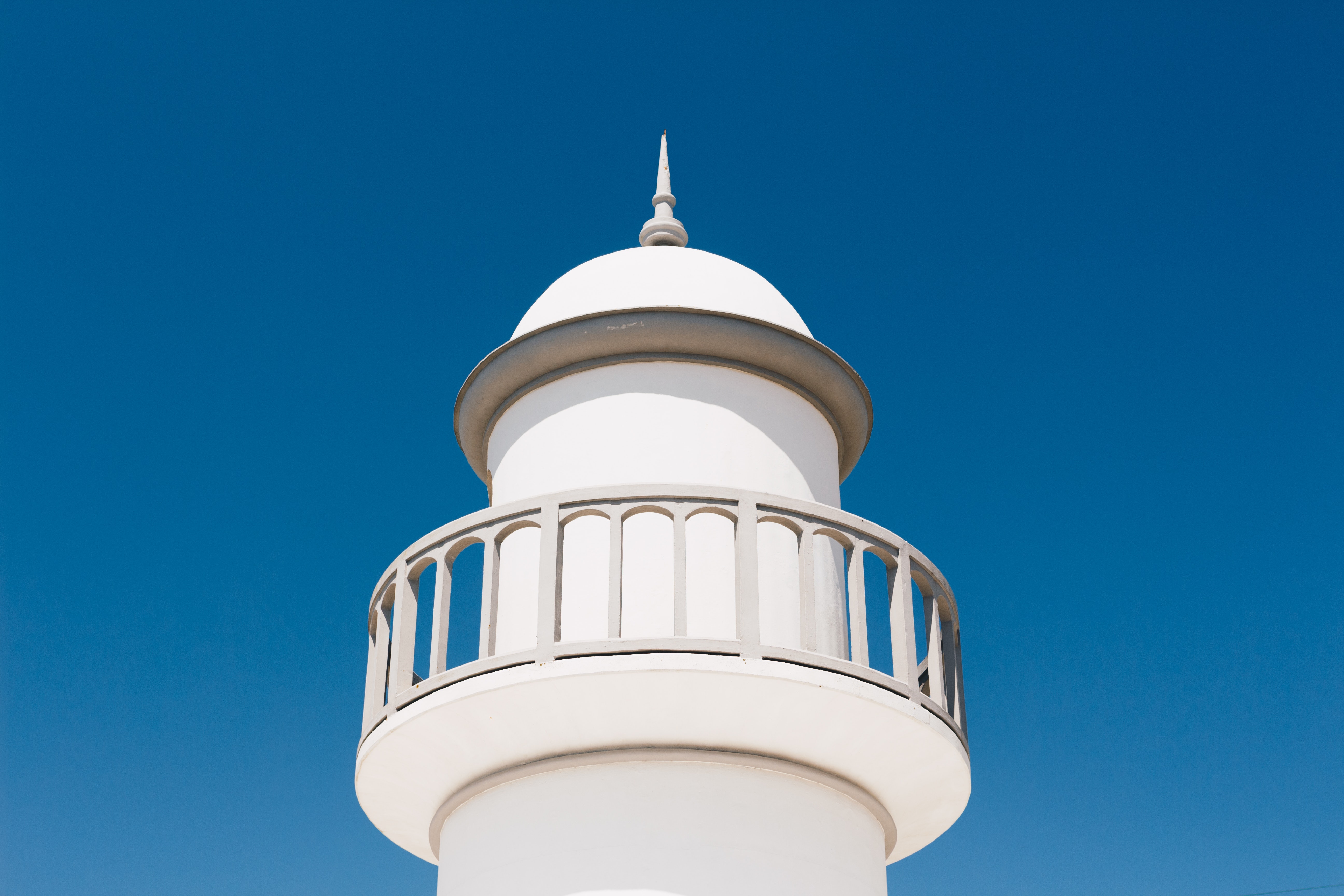 White lighthouse under blue sky photo