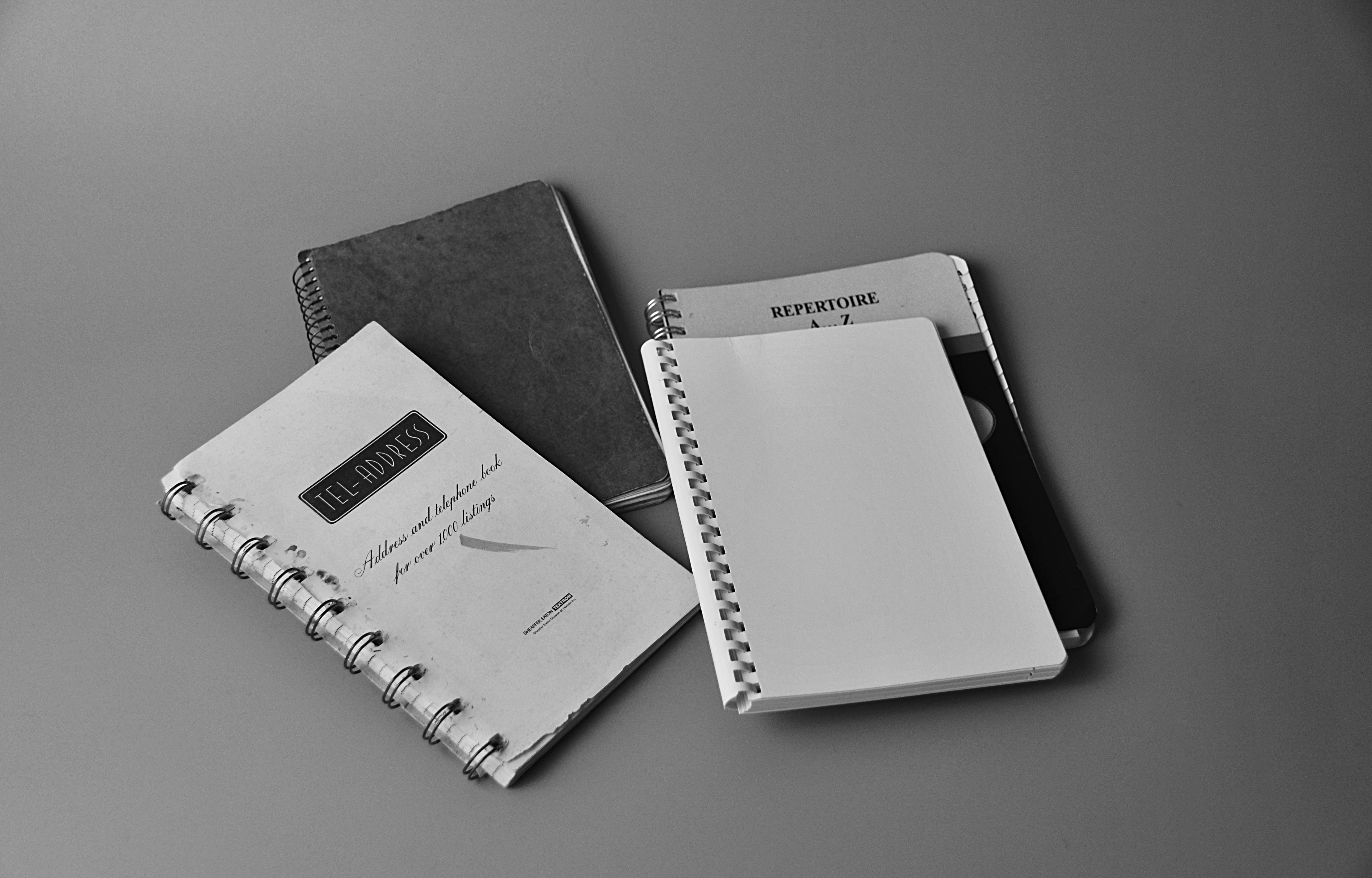 White notebook on white and black book photo