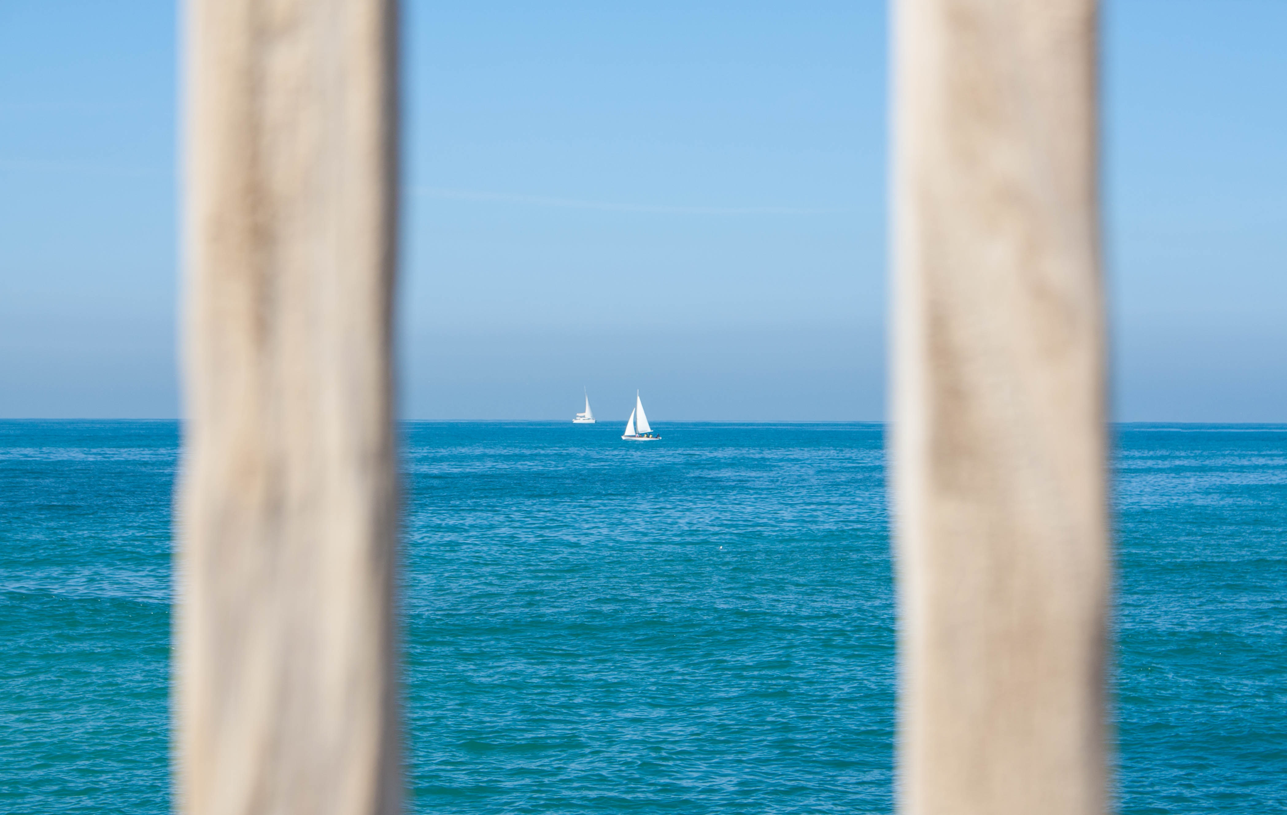 White sailing boat on body of water photo