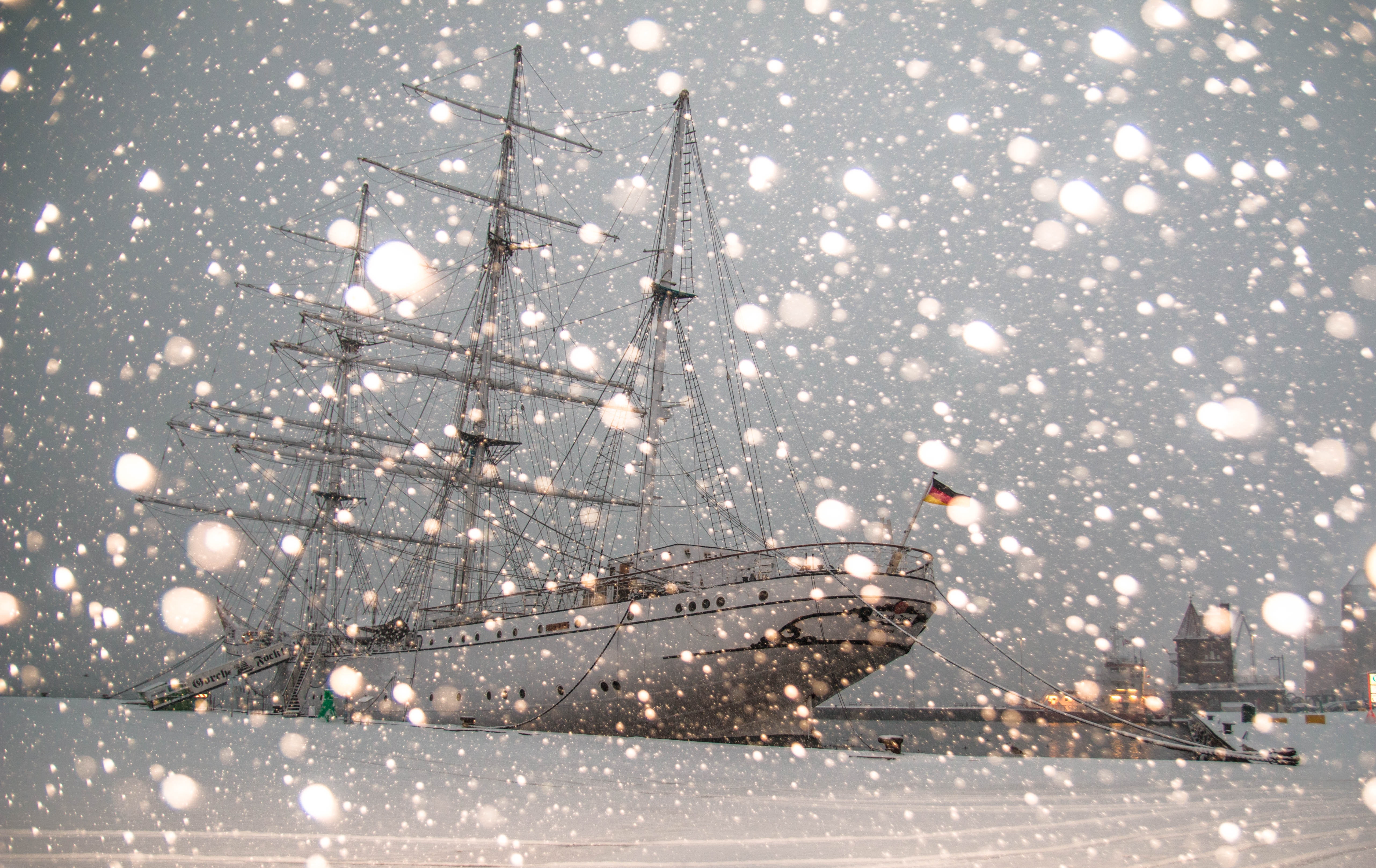 White sailing ship docked at pier photo