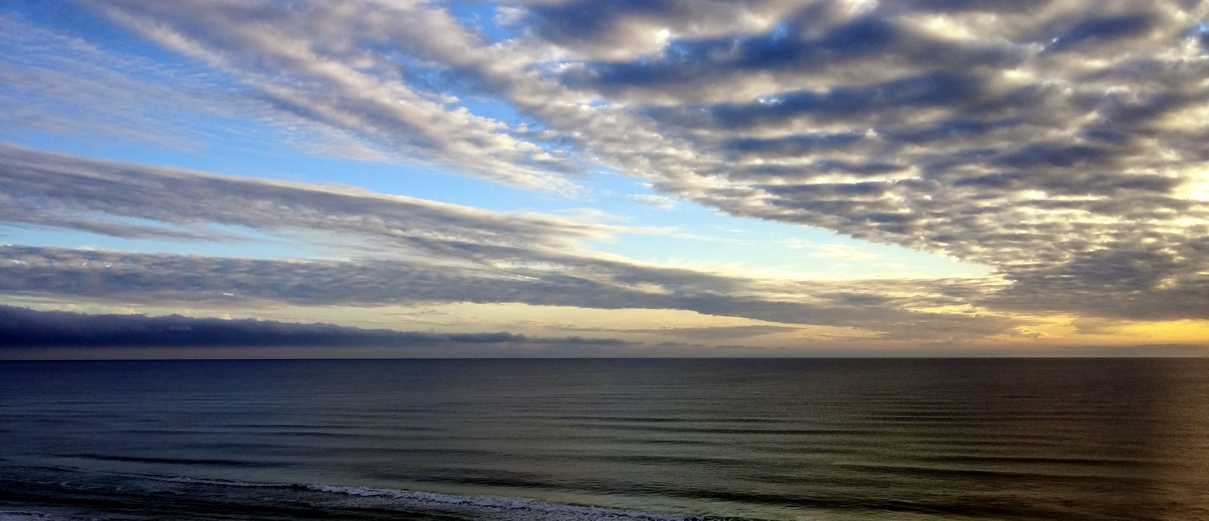 White sky under blue sea during dawn photo