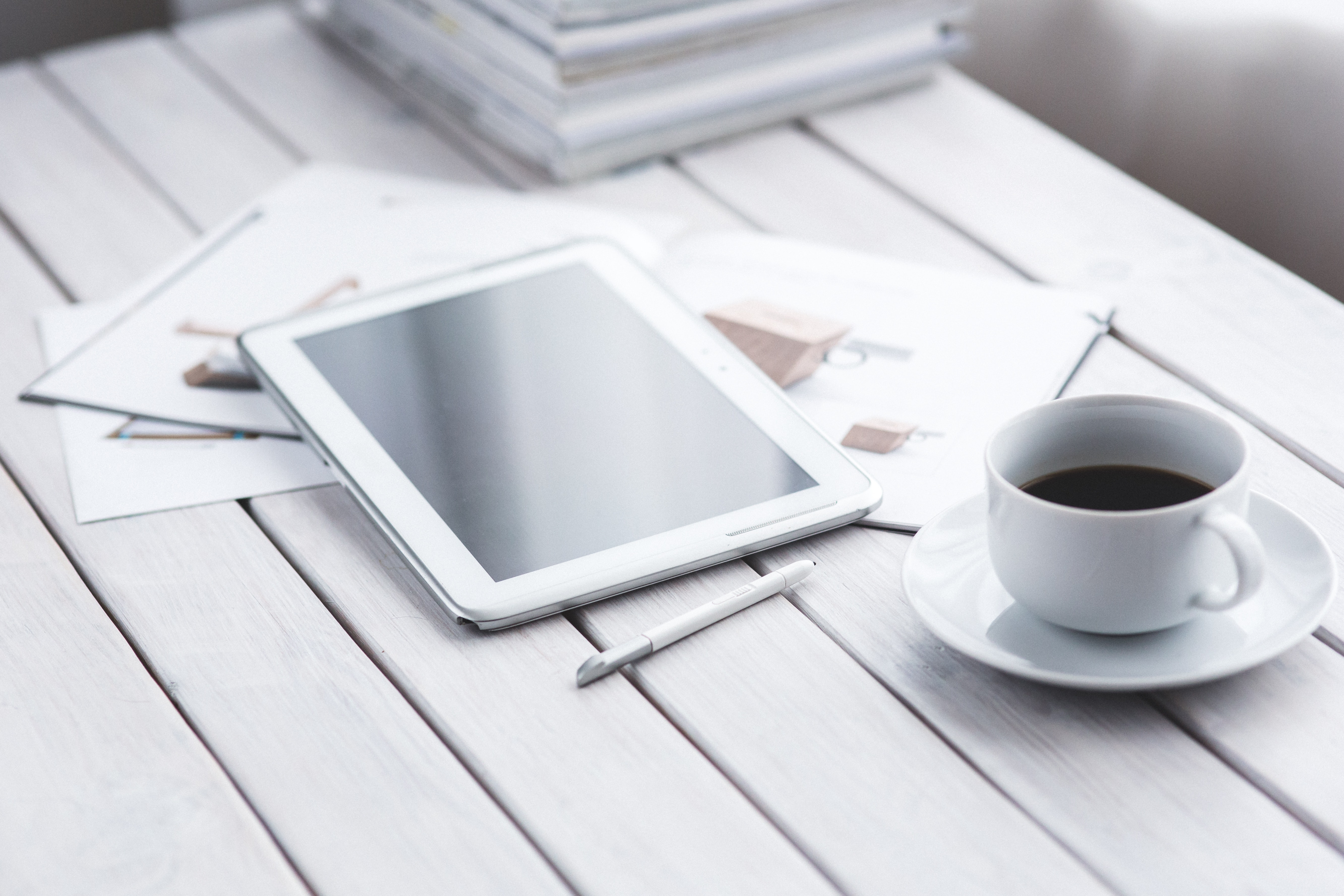 White tablet and cup of coffee photo