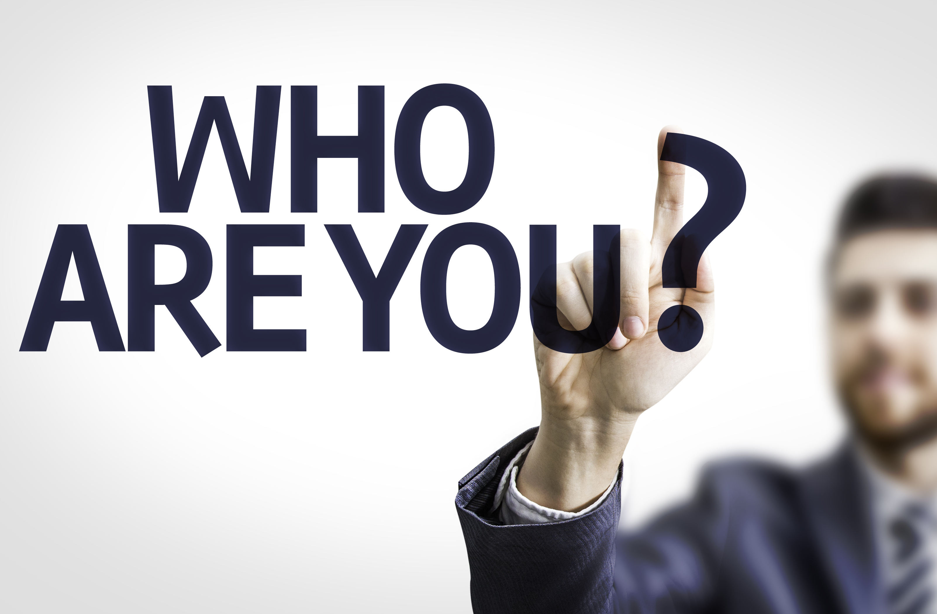 Business man pointing the text: Who are You? – Unity of Nashville
