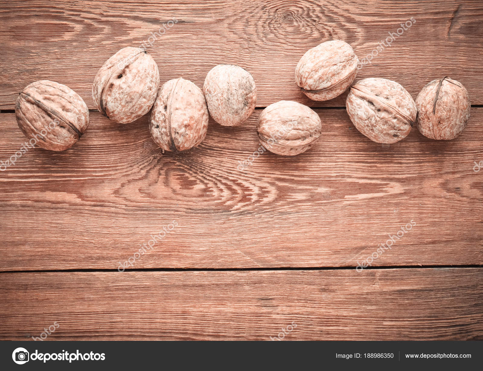 Many walnuts in a shell on a wooden table. Copy space. Top view ...