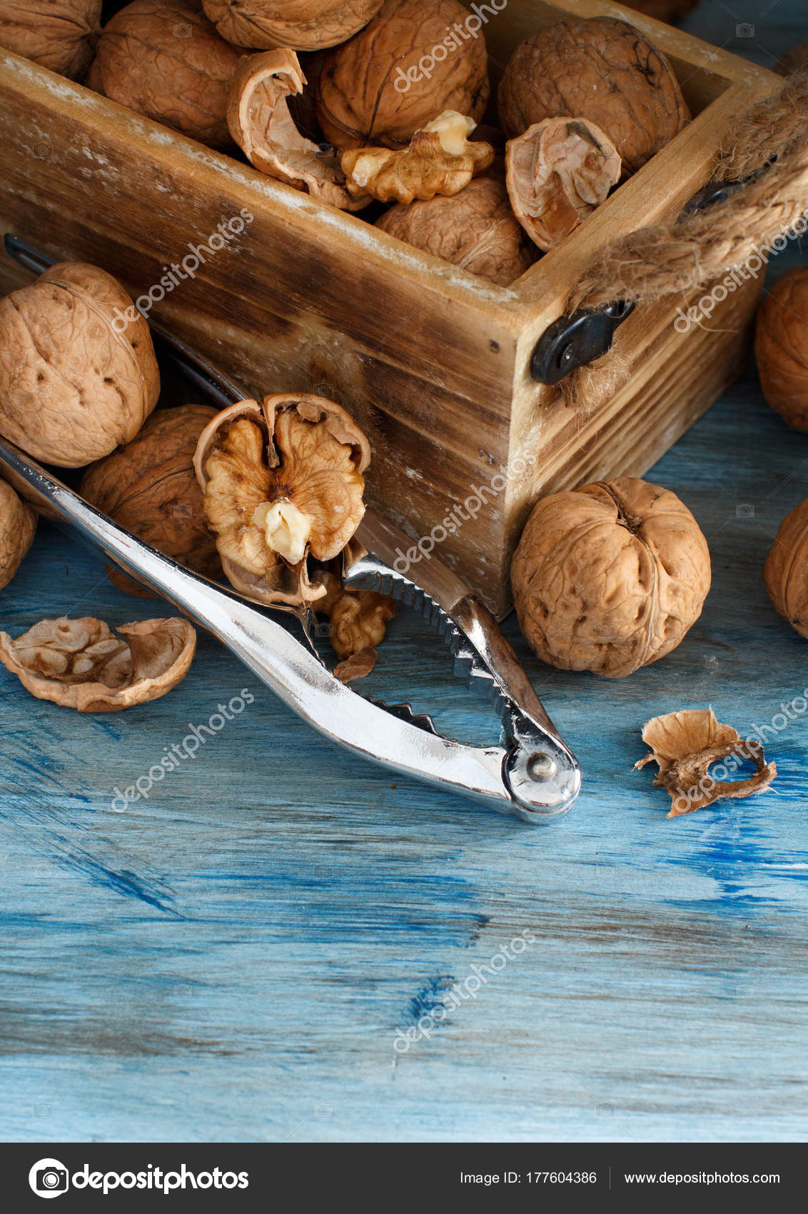 Fresh walnuts on a blue wooden table — Stock Photo © karissaa #177604386