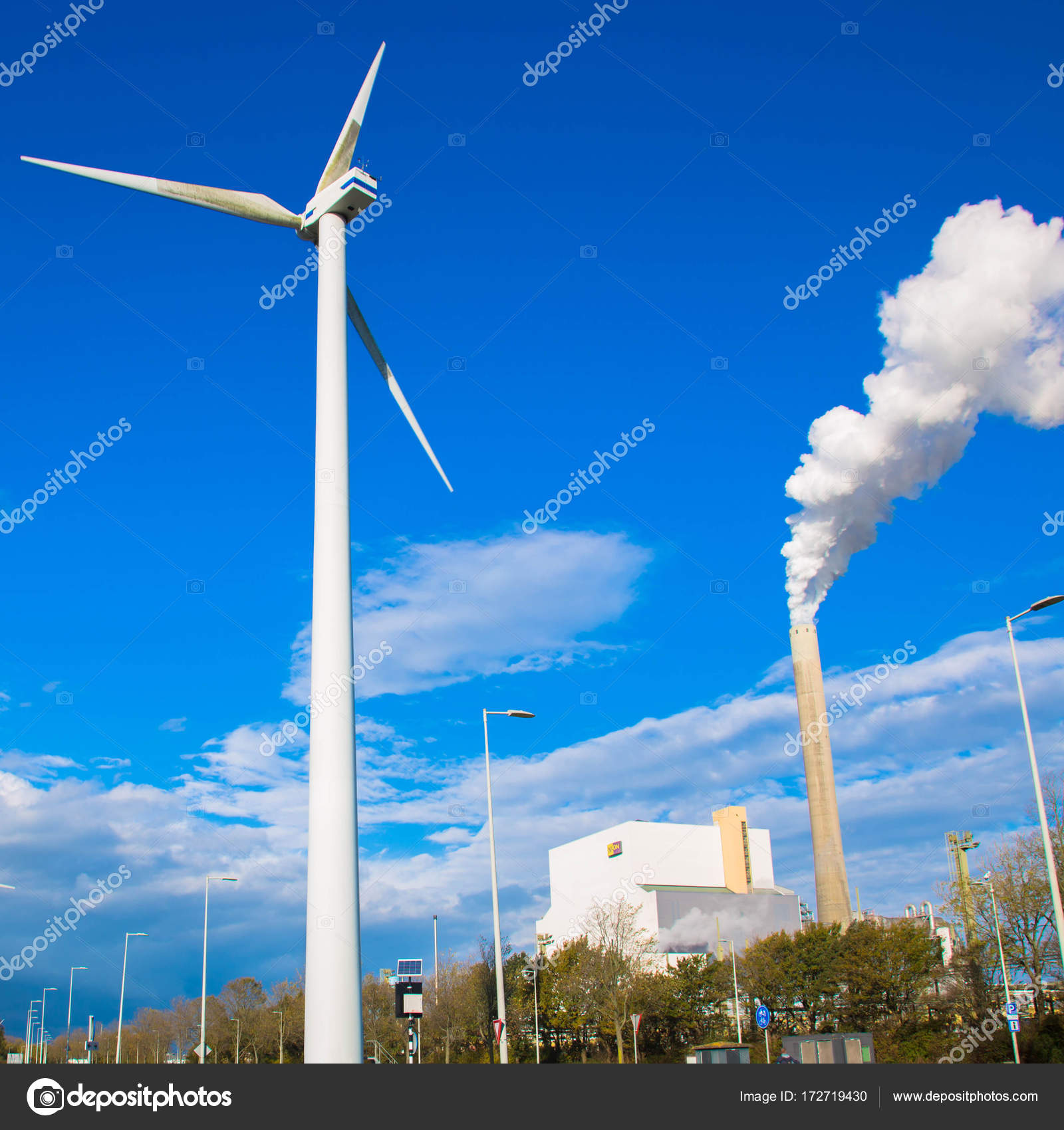 Climate problems. An electric windmill and factory chimney — Stock ...