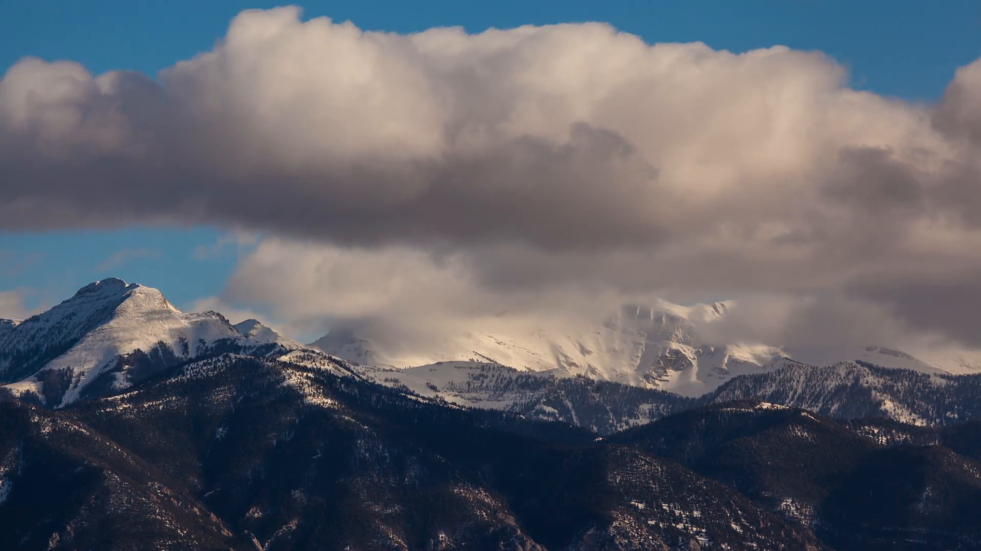 Timelapse of clouds flowing over winter mountains in snow - WideMtn ...