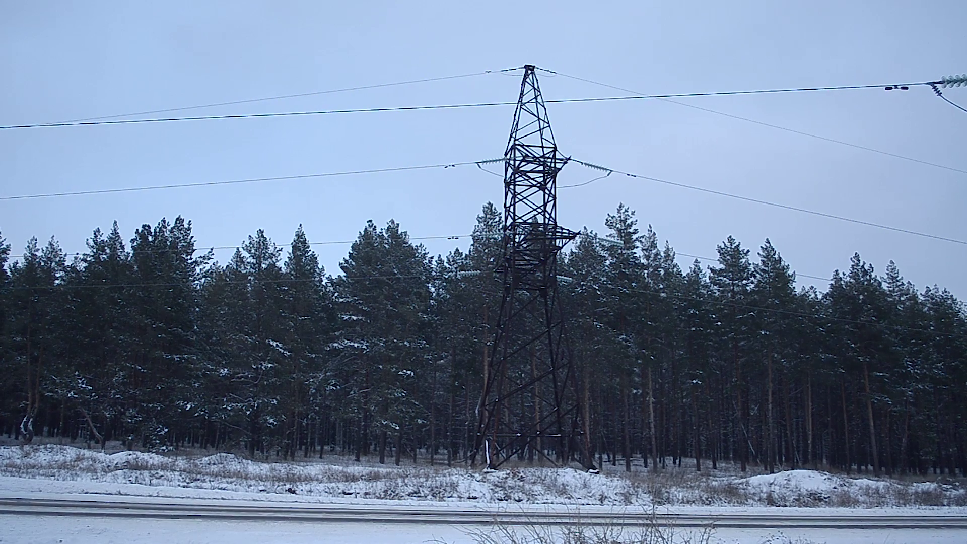 Electricity pylons and lines against the evening winter forest Stock ...