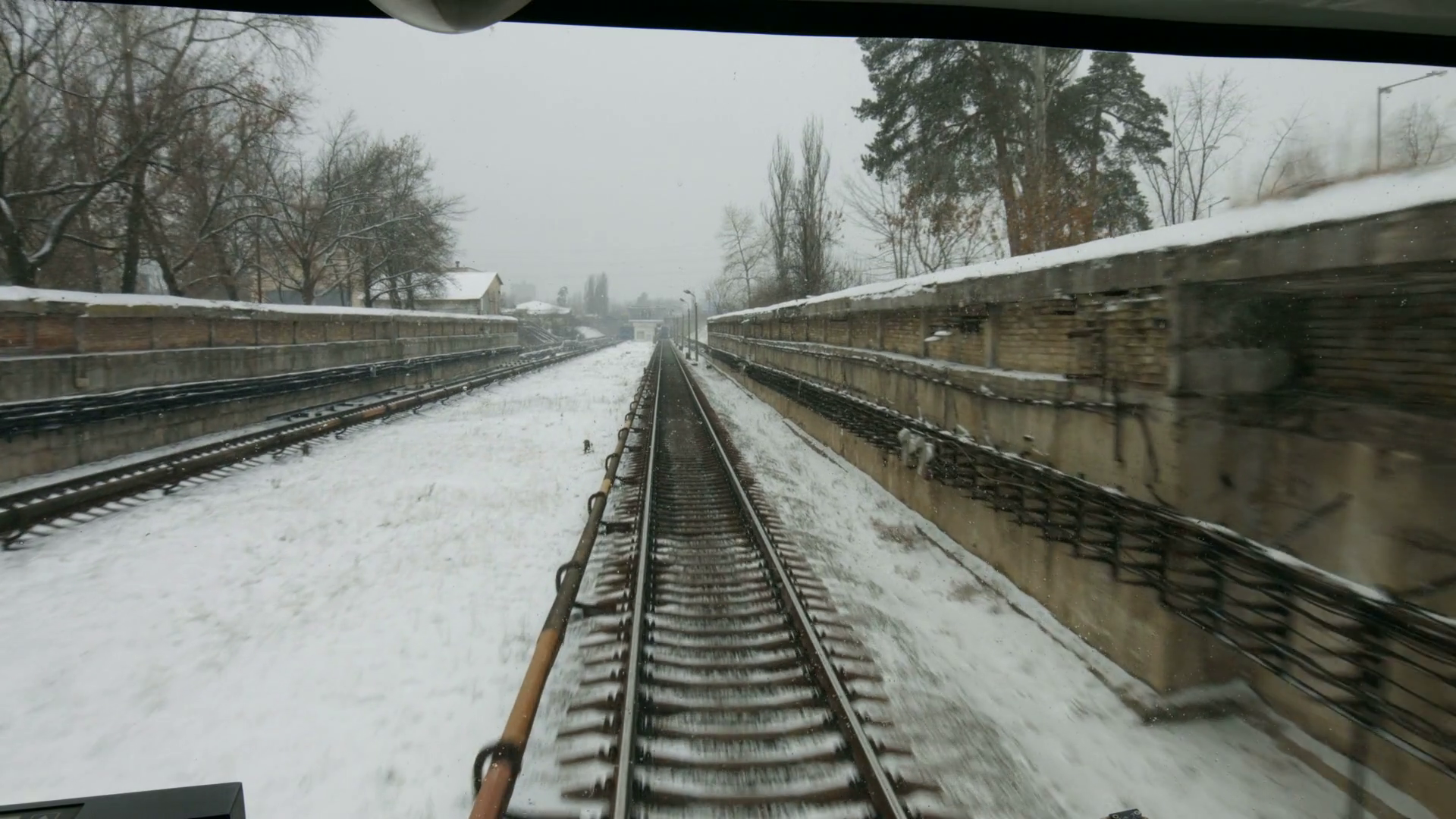 View from the driver's cab. Electric train goes on rails. Winter ...