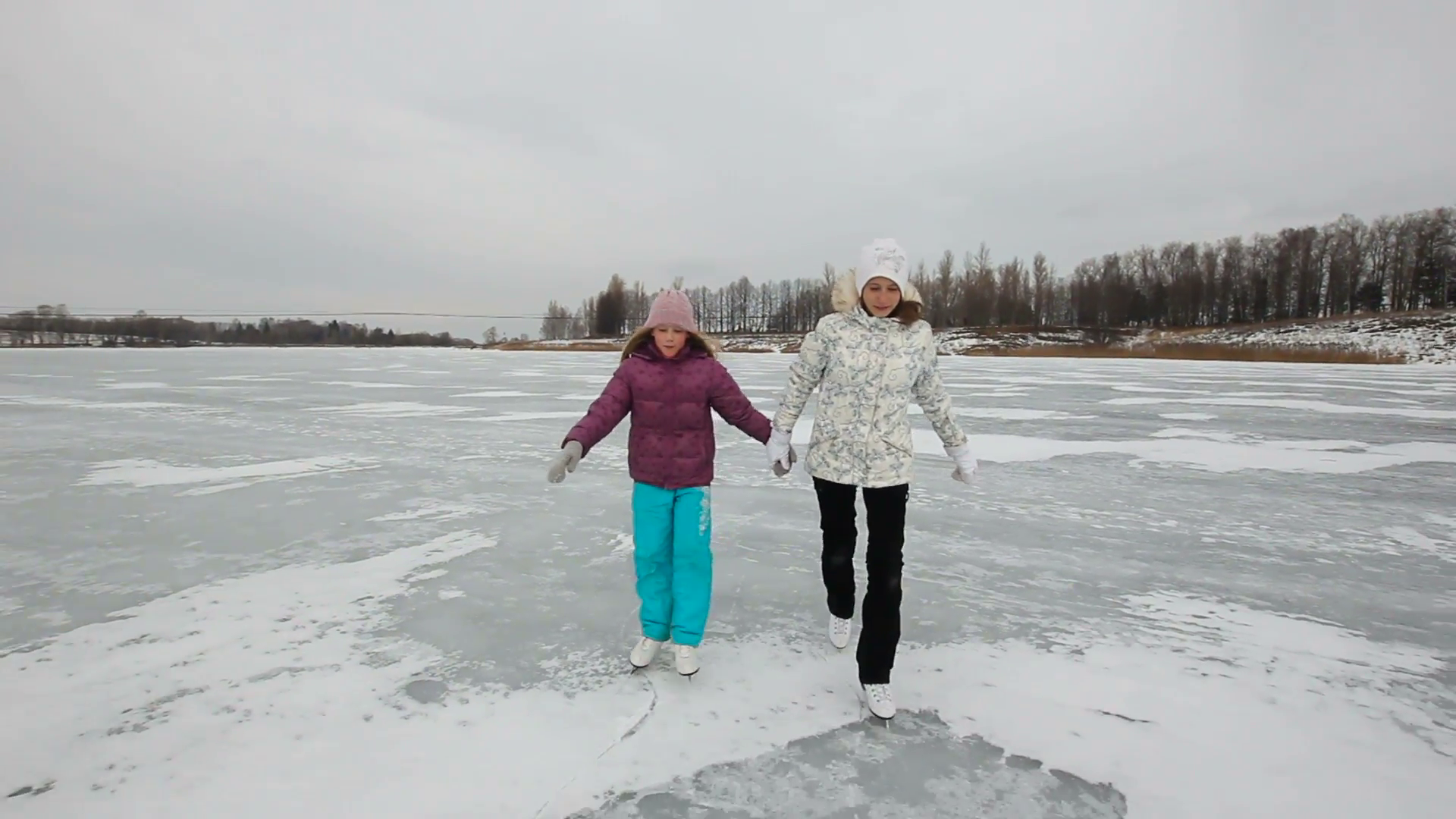 Happy girls ice skating in natural rink frozen lake.Ice skaters on a ...