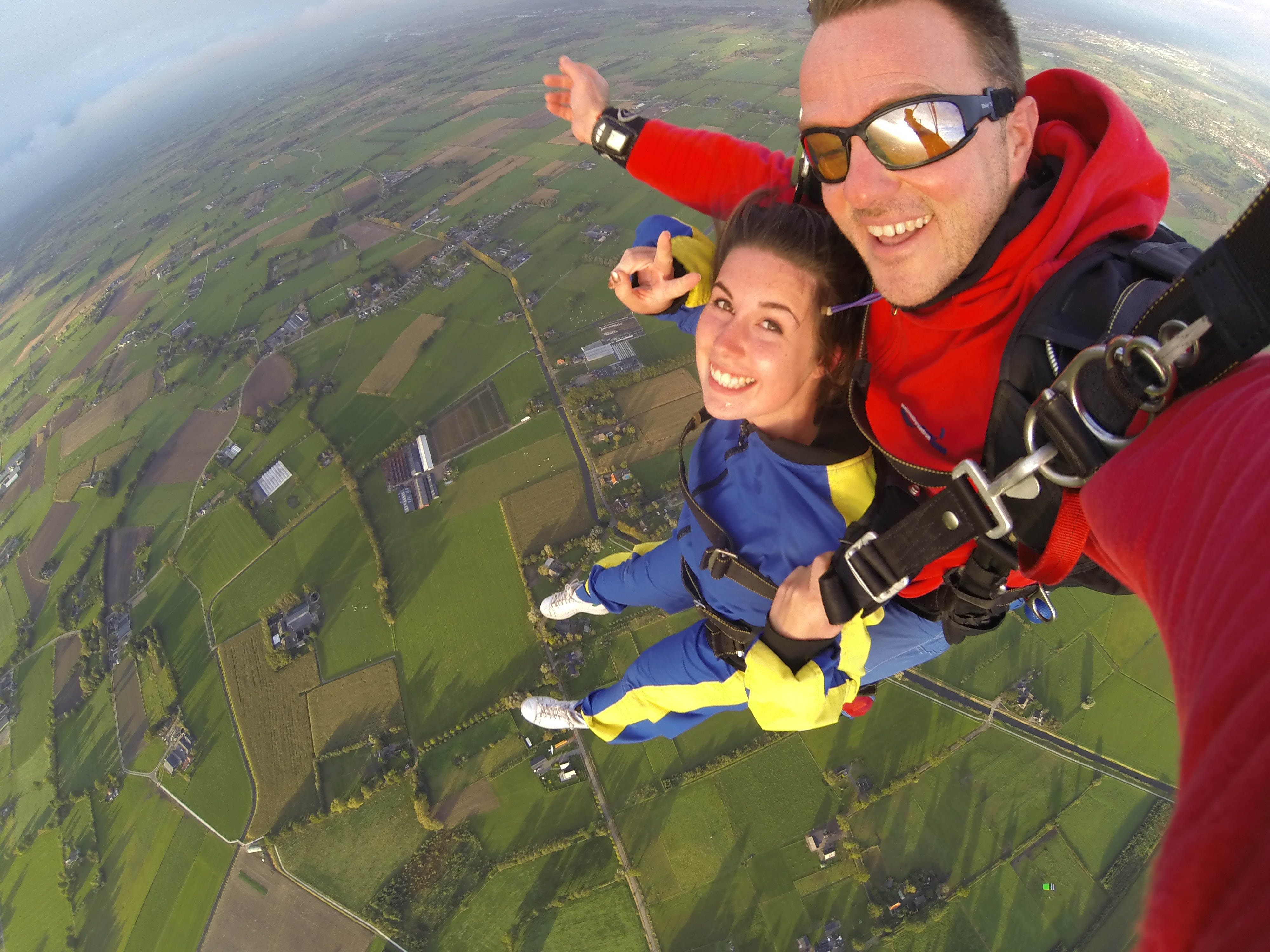 Woman and man wearing overalls sky diving photo