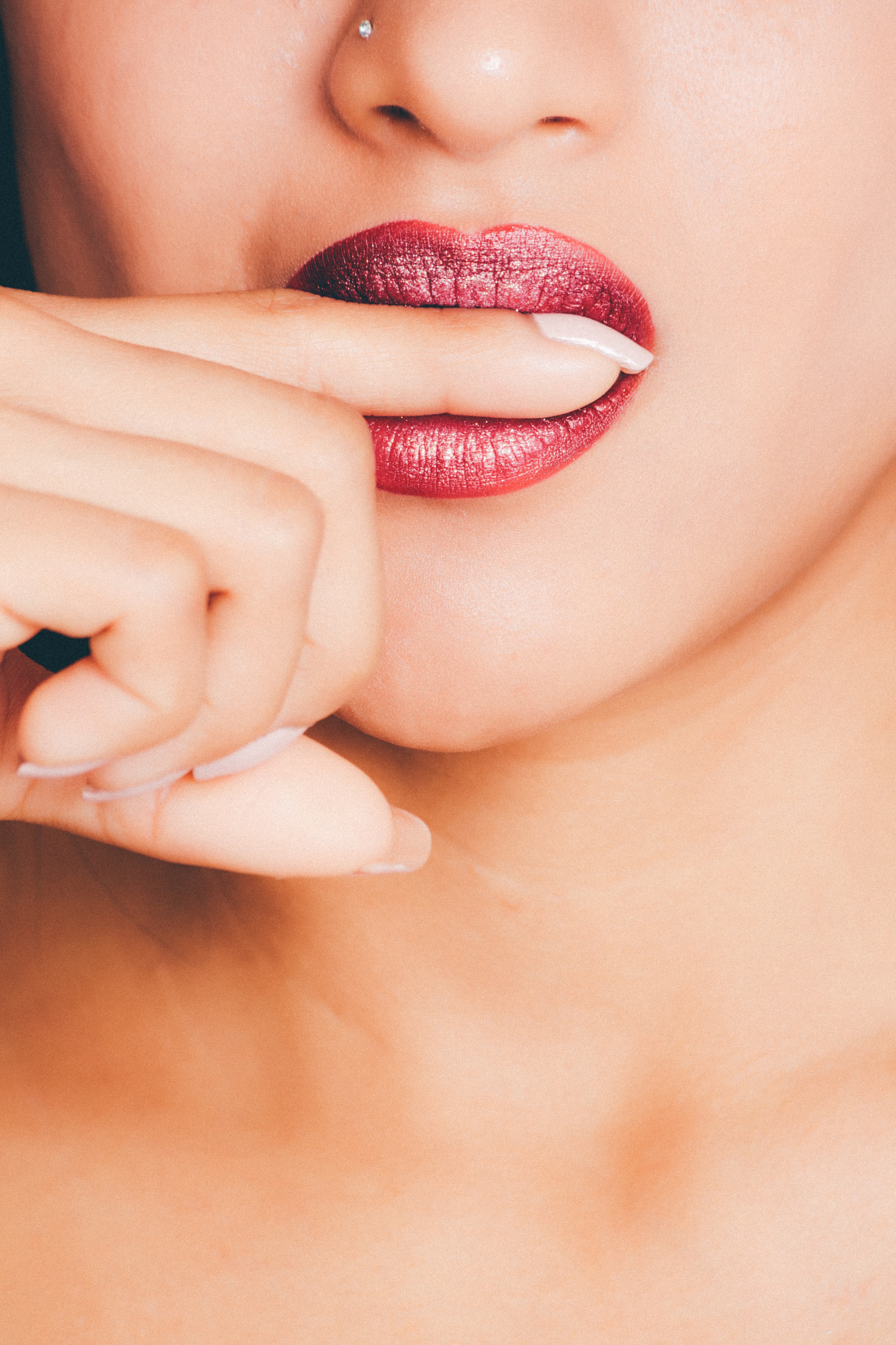 Woman biting index finger photo