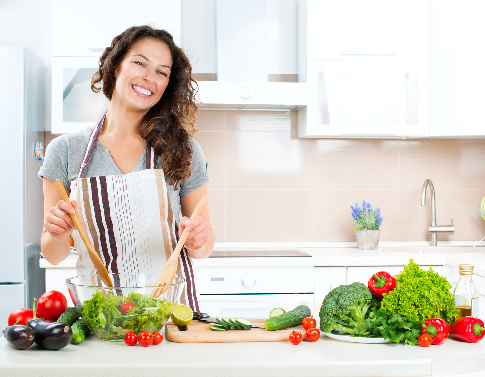 Young Woman Cooking in the kitchen. Healthy Food - Vegetable Sal ...
