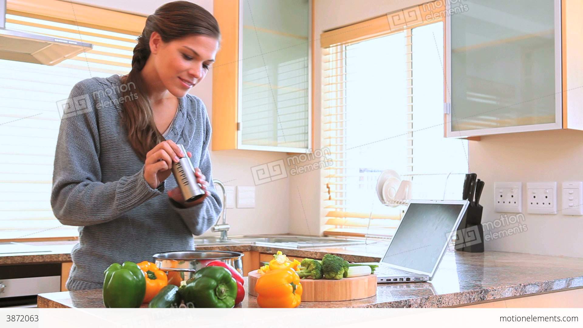 Woman Cooking While Looking At The Recipe Stock video footage | 3872063