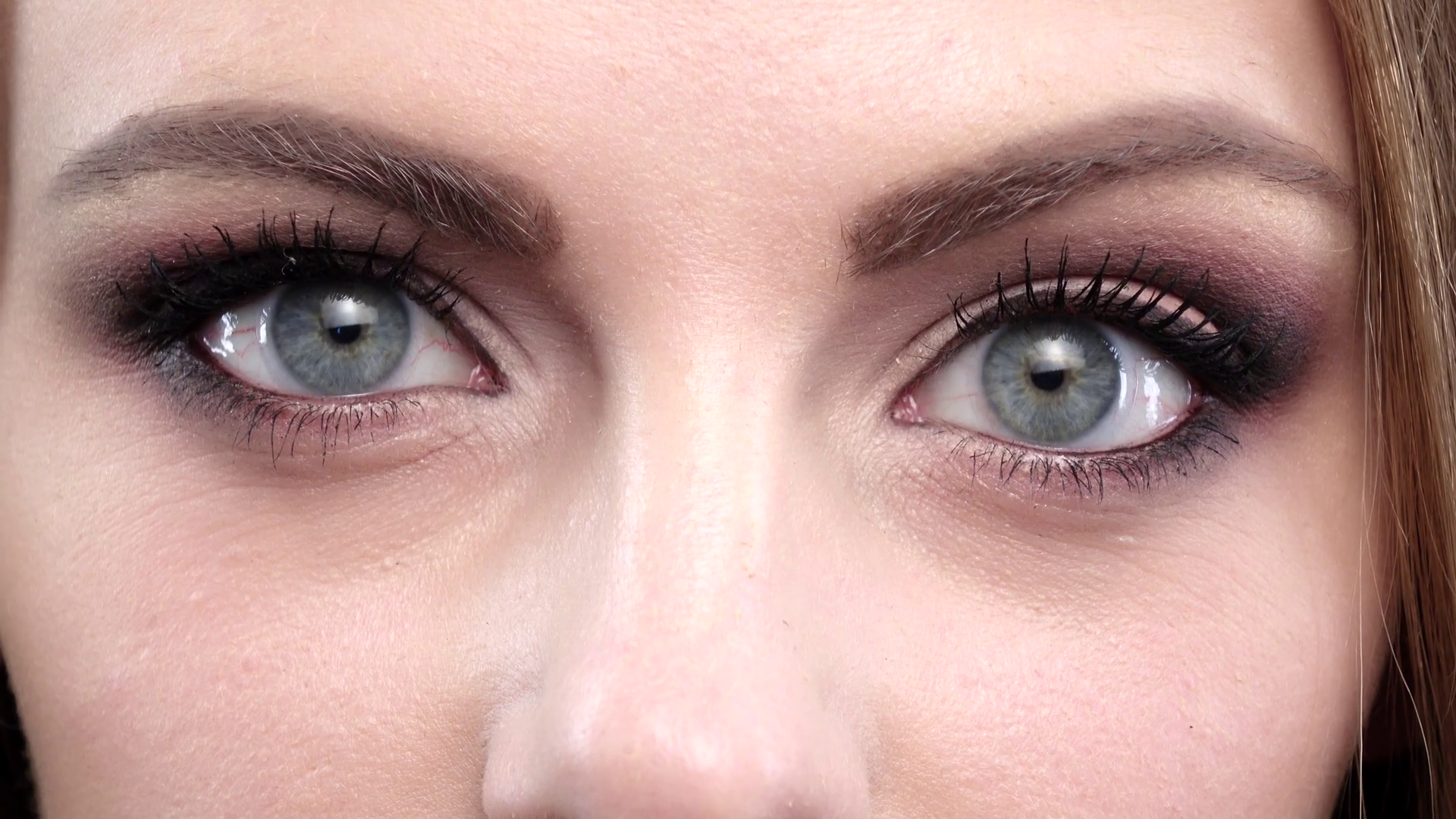 Woman winking. Blue eyes. Closeup Stock Video Footage - Videoblocks
