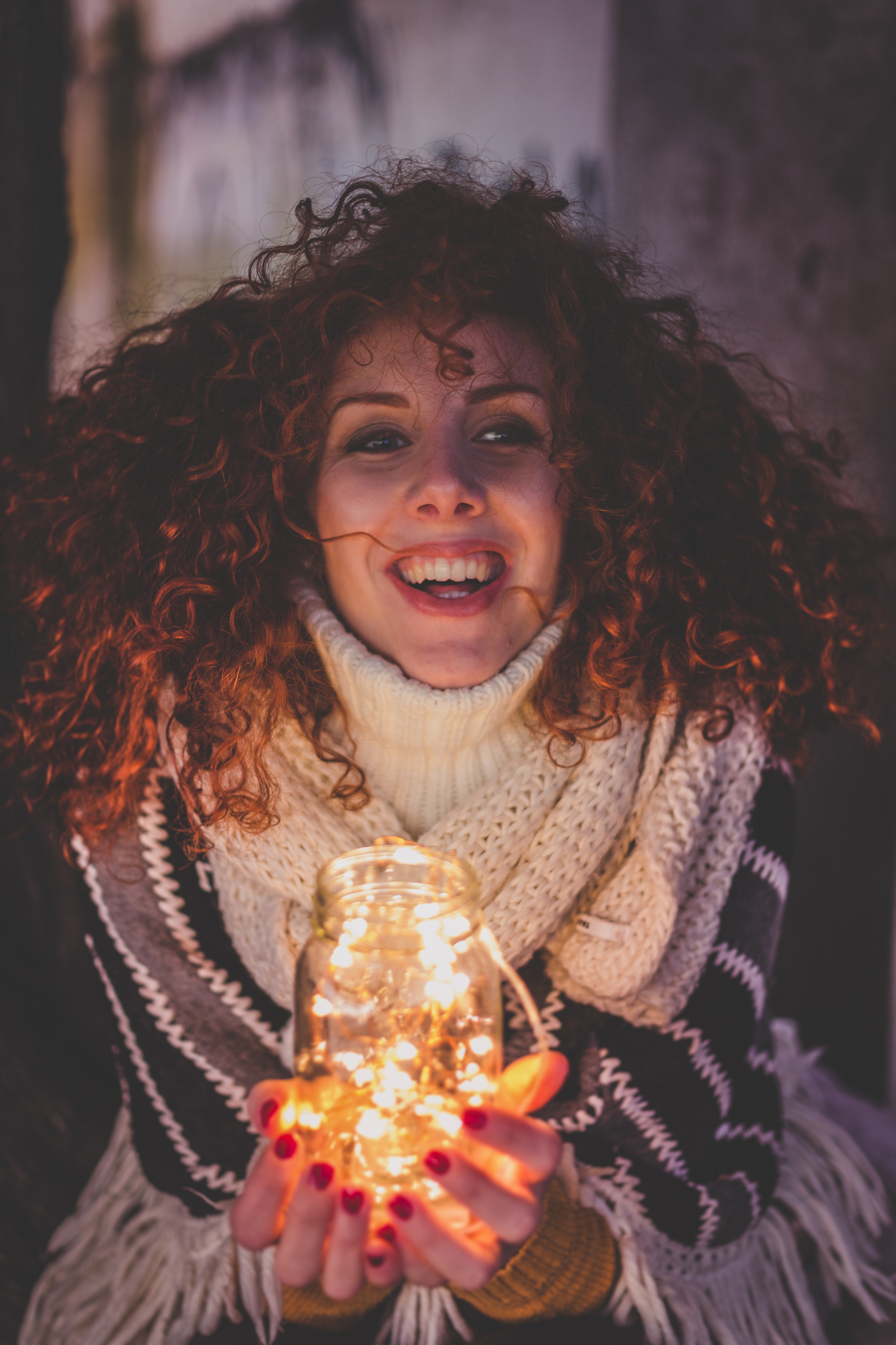 Woman holding a jar with string lights photo