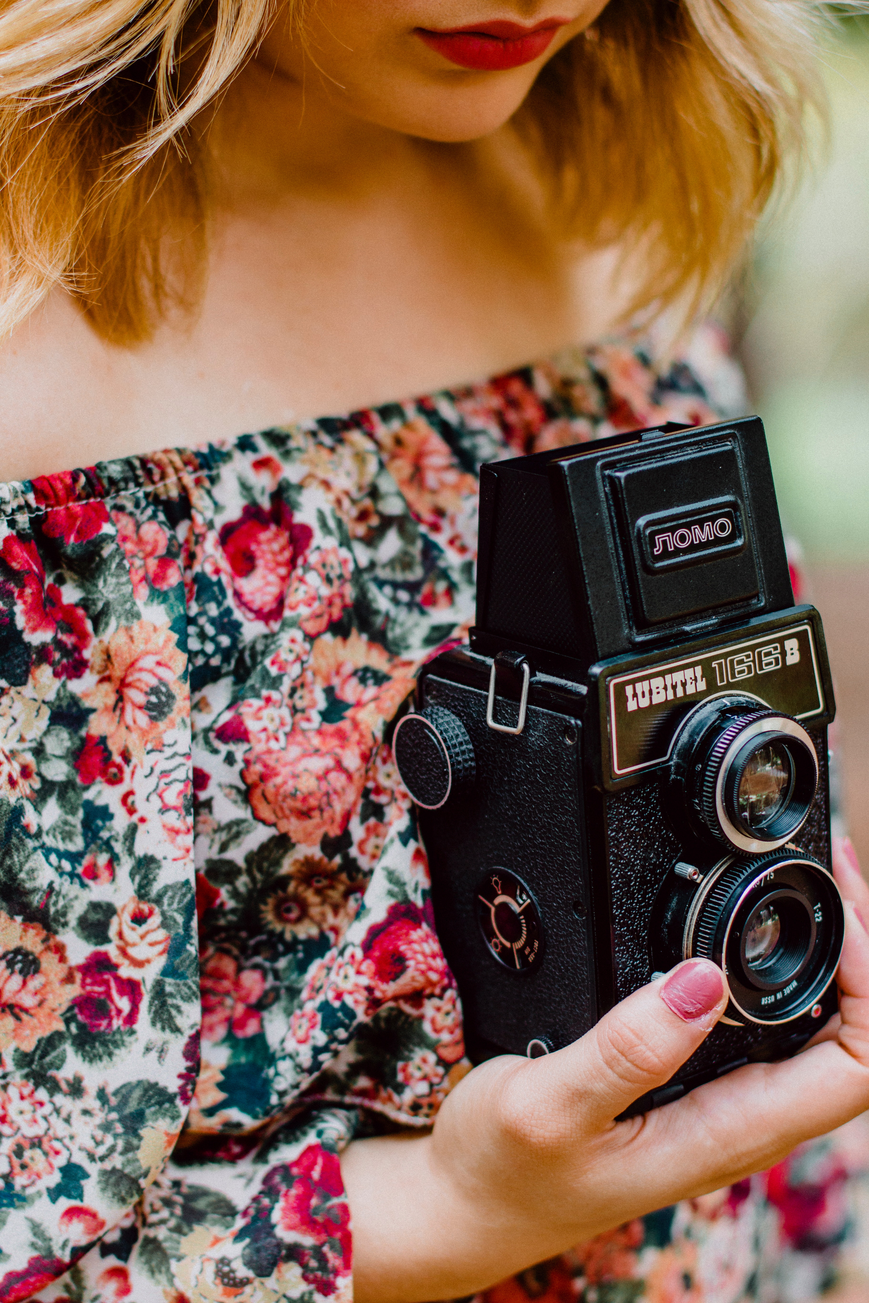 Woman holding black nomo vintage camera photo