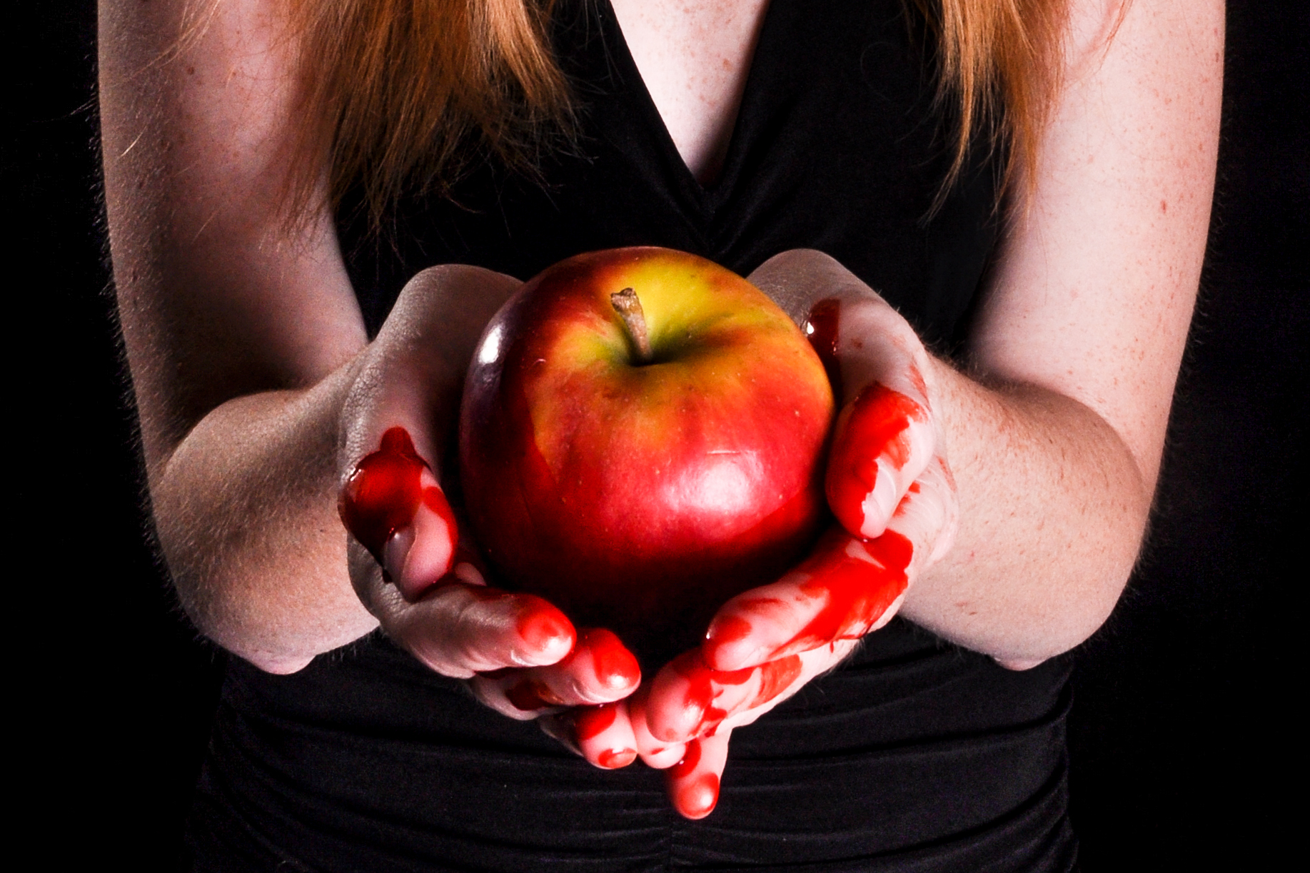 Woman holding bleeding apple sin photo