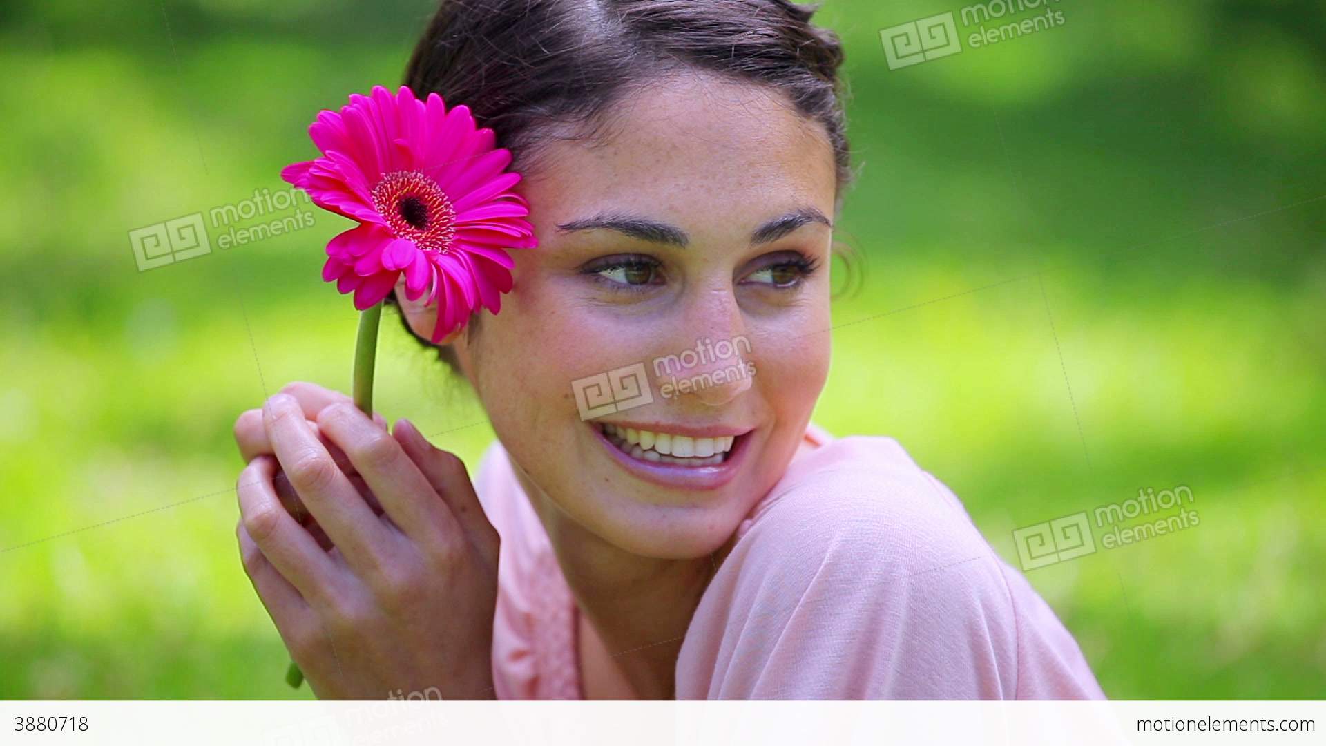 Happy Brunette Woman Holding A Pink Flower Stock video footage | 3880718