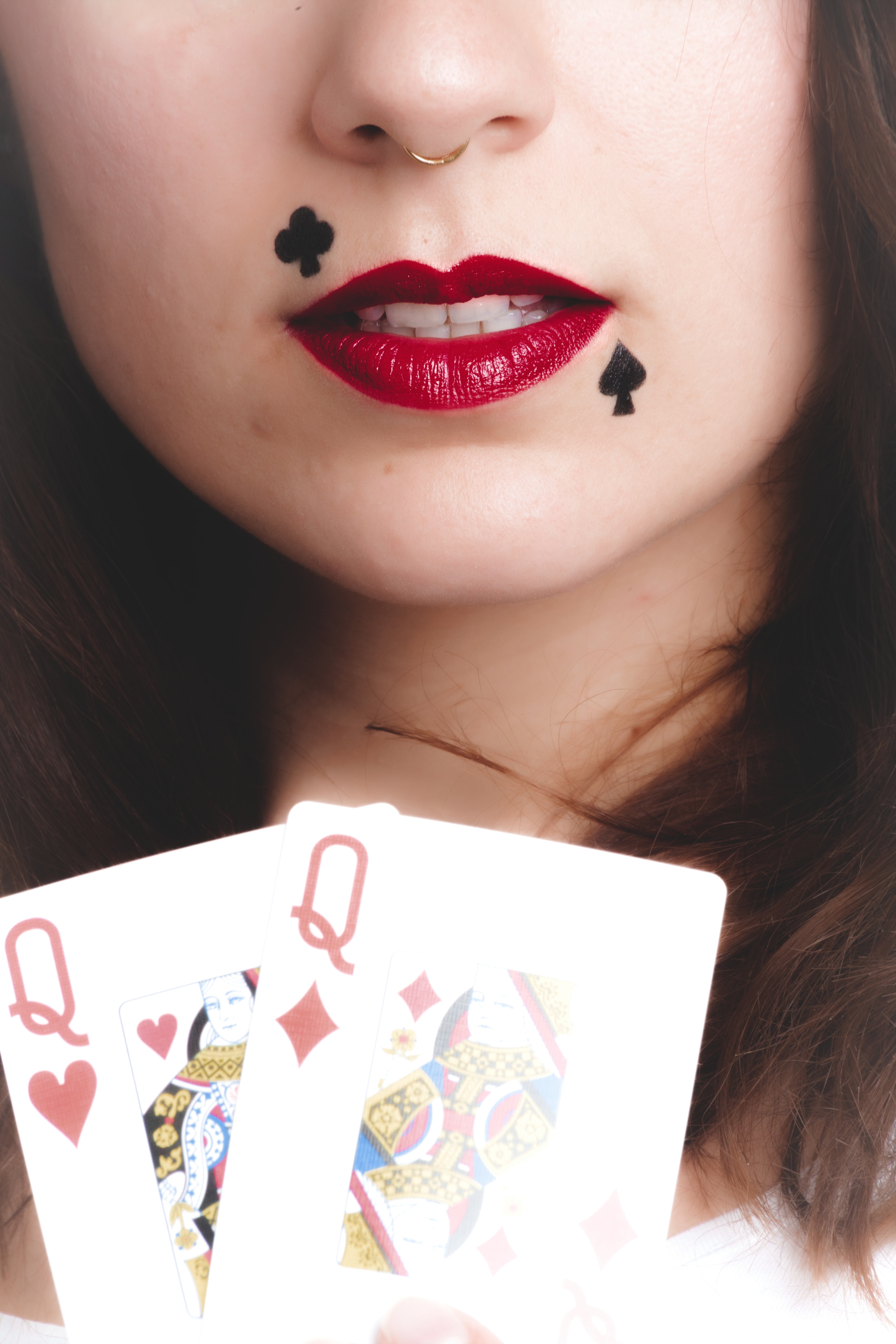 Woman holding queen of hearts and diamonds photo