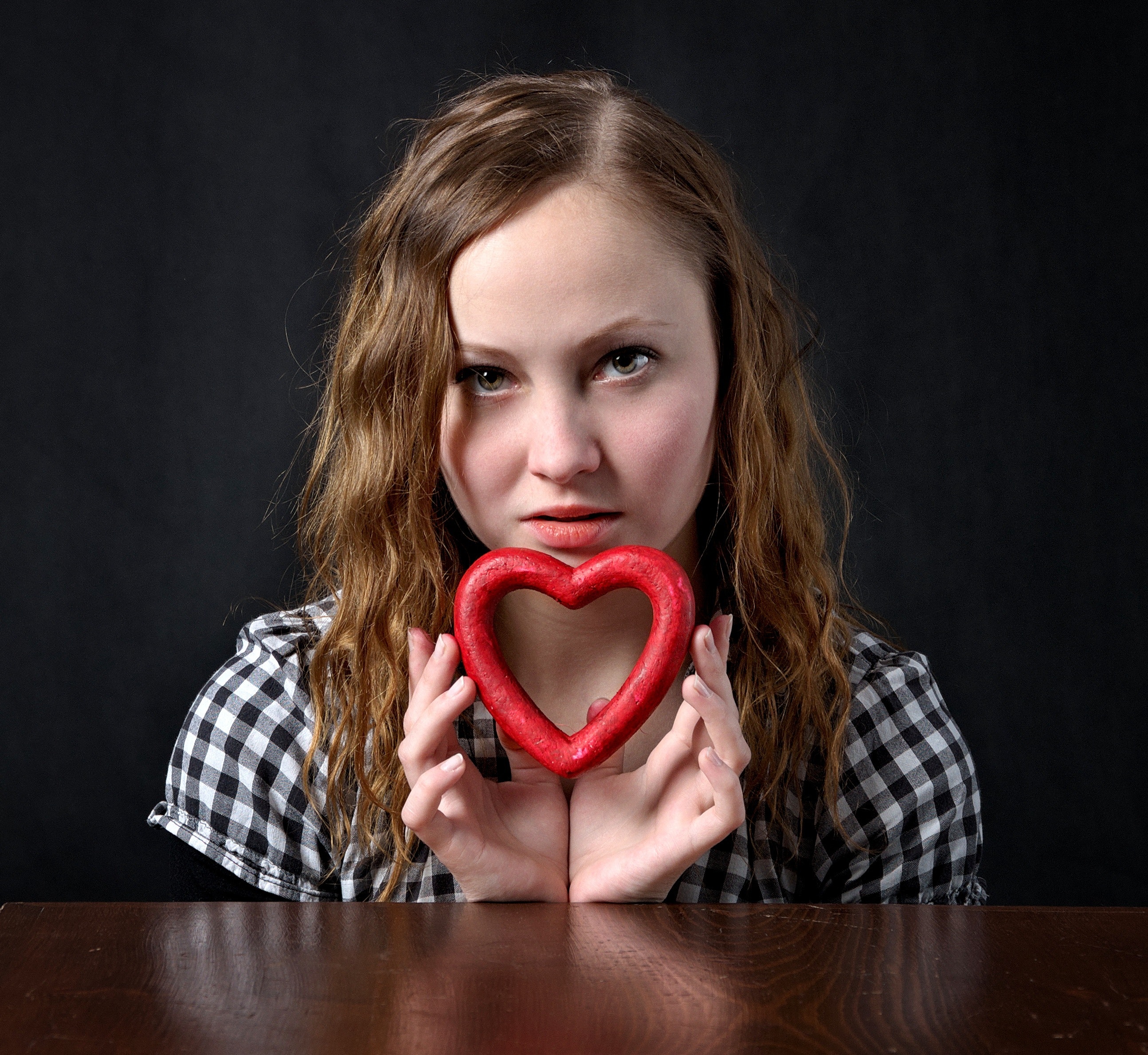 Woman holding red heart shape ornament photo